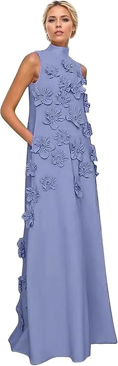 A woman wearing a long, sleeveless, light blue dress with floral appliqué details.