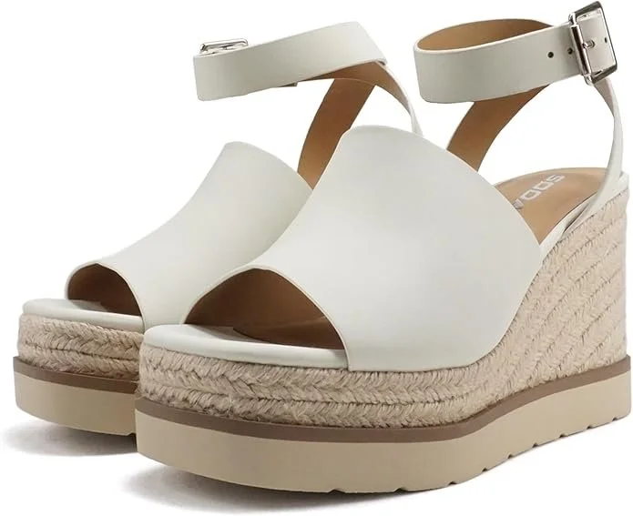 White platform espadrille wedge sandals with ankle straps and buckle closures.
