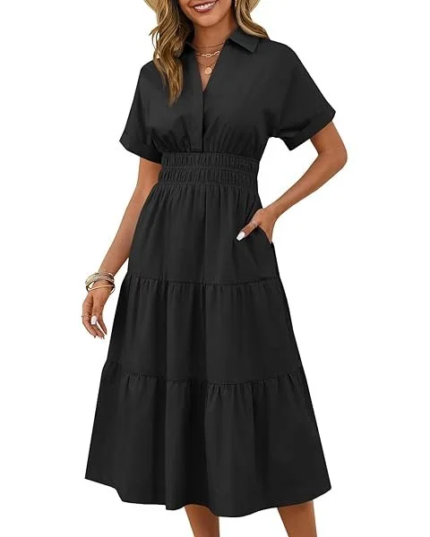 A woman wearing a black, short-sleeved, collared maxi dress with a tiered skirt and an elastic waist.
