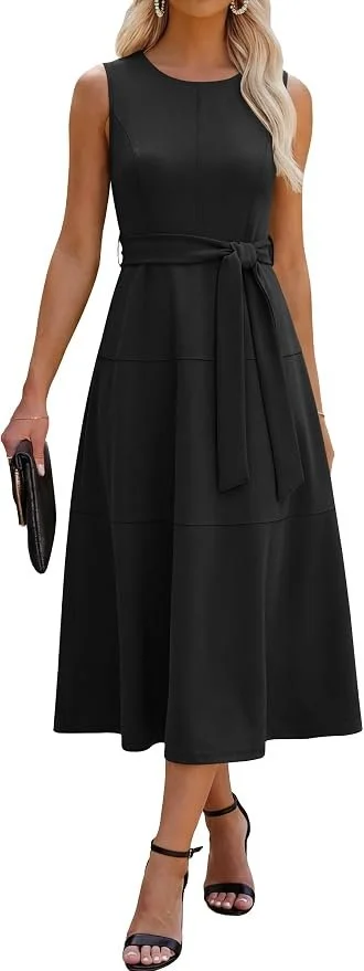 A woman wearing a sleeveless black midi dress with a waistband tie, black high-heeled sandals, and holding a black clutch purse. She has long blonde hair and is wearing earrings.