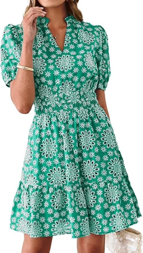 Woman wearing a green dress with a white floral pattern, short puff sleeves, and a belted waist.