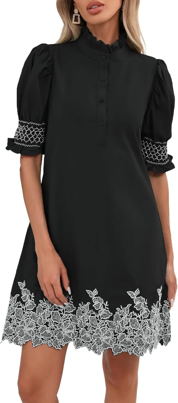 Black dress with puffed sleeves, lace embroidery at the hem, and pleated details on the sleeves, worn by a woman with earrings.