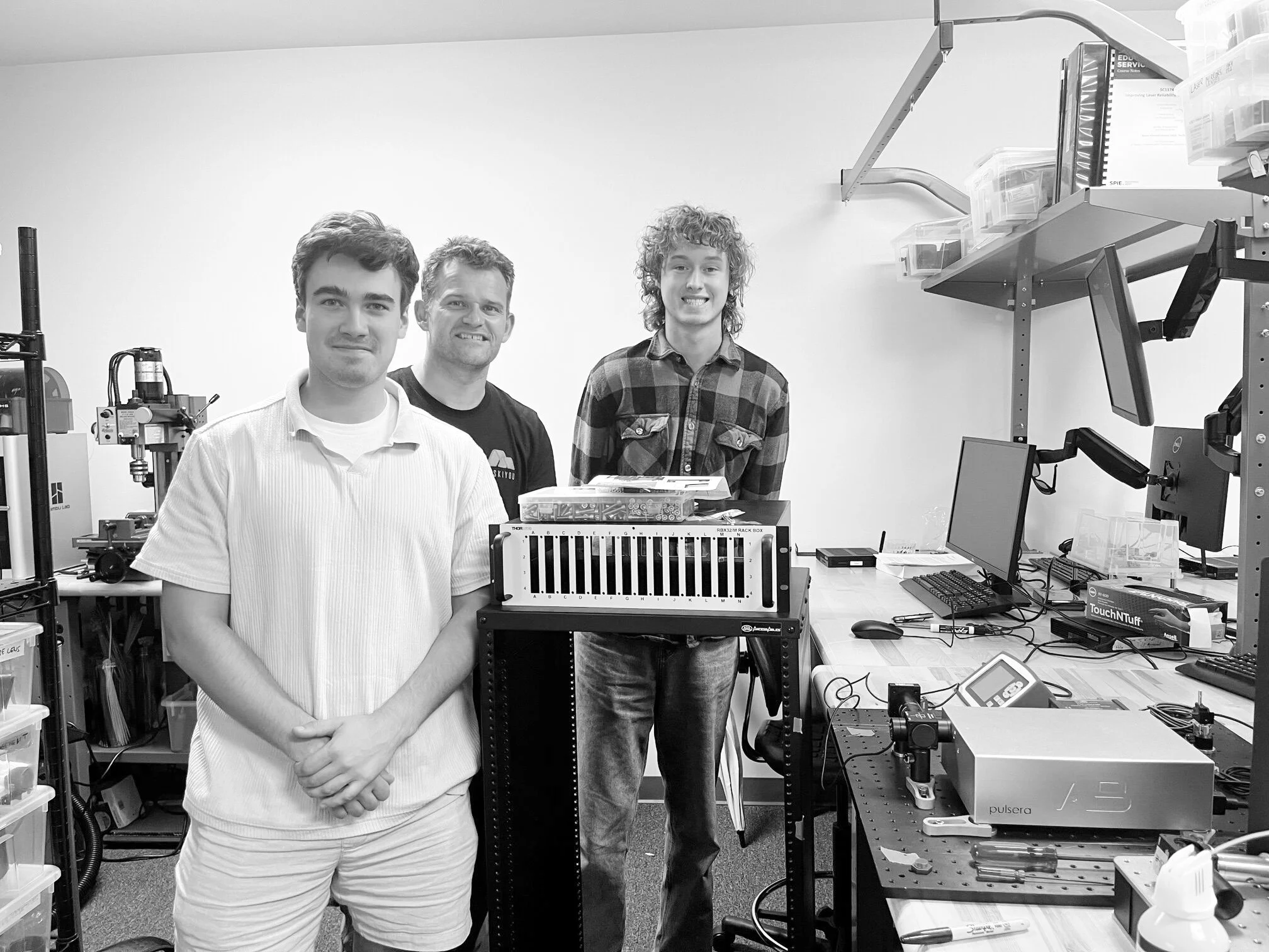AB Photonics engineers working with optical equipment in a laboratory.