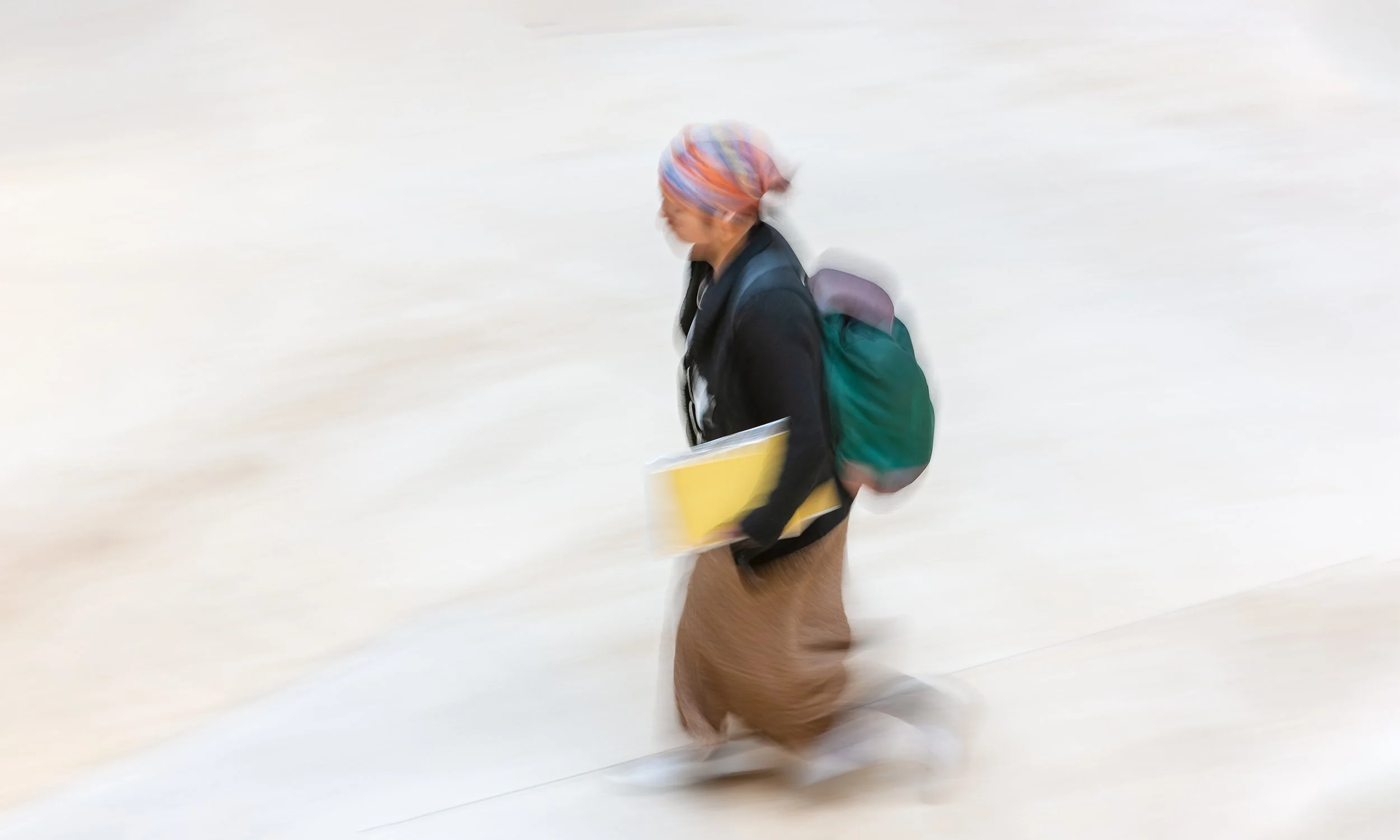A distinctively dressed passer-by caught in motion — from Ken Holden's Individual Personae collection, celebrating the diversity of people in public.