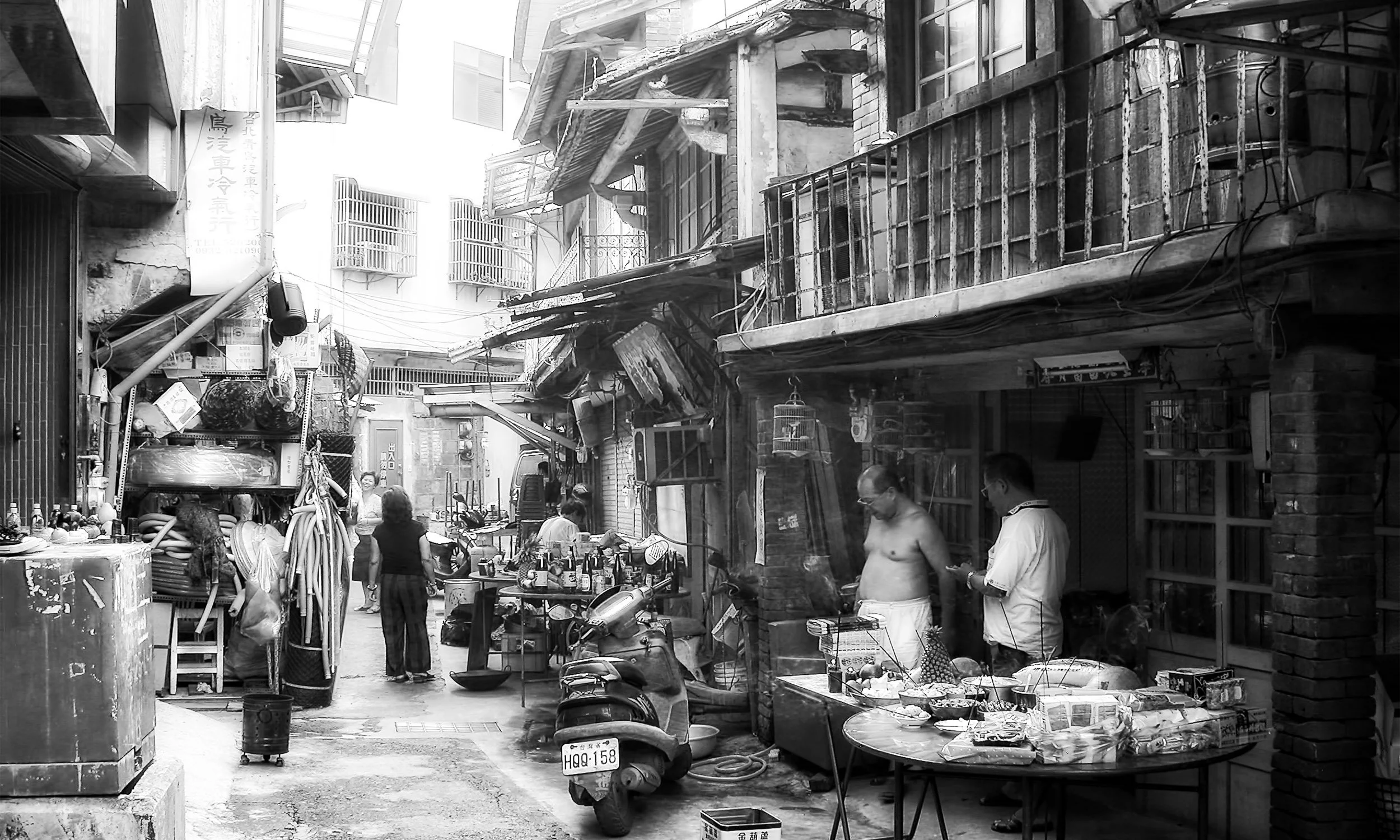 A black-and-white street scene in Hsinchu City, Taiwan during the Ghost Festival — from Ken Holden's Monochrome collection.