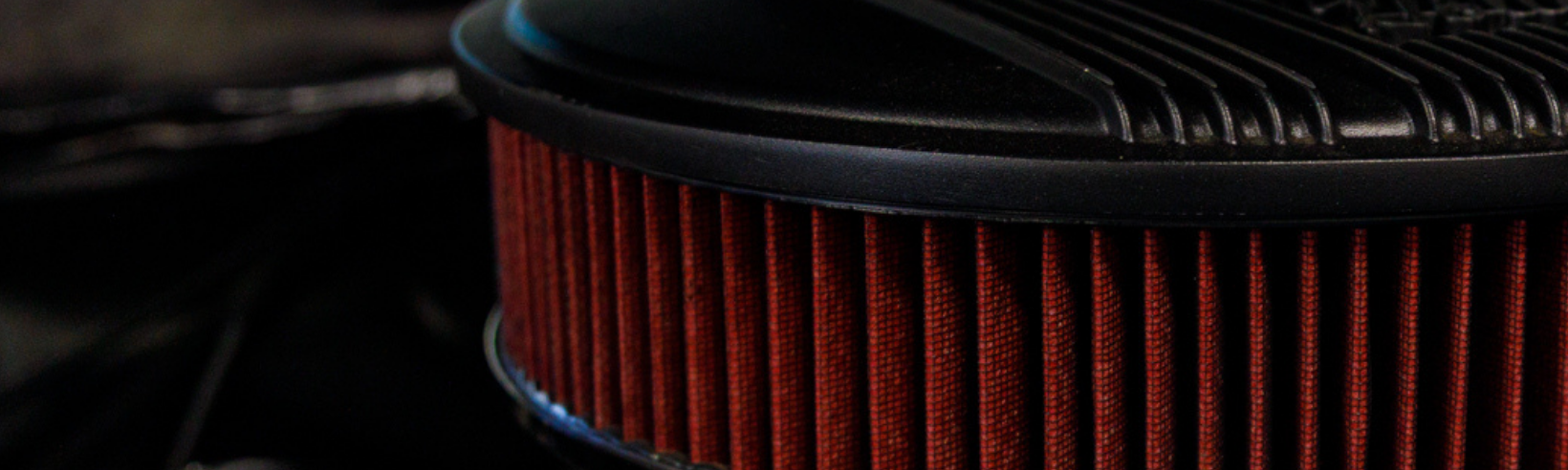 engine bay with bright red round carb filter