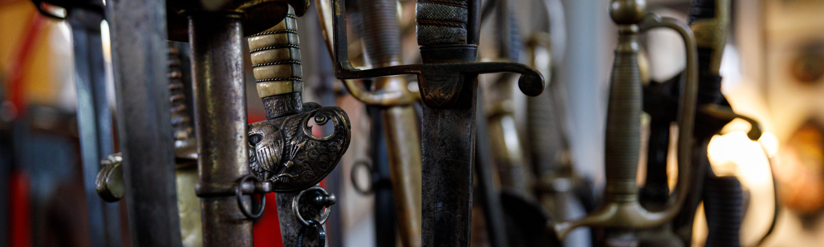 antique military sword hilts with eagle crest on the hilt of one in focus