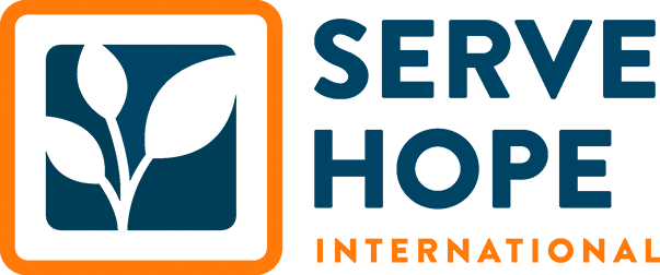 Logo of Serve Hope International featuring a stylized plant and the organization's name.