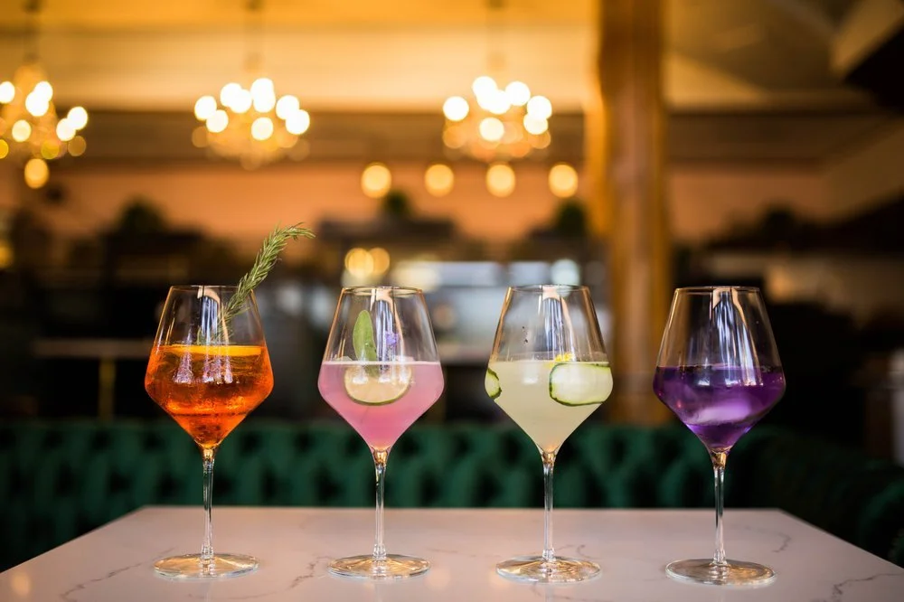 4 cocktail glasses with garnishes