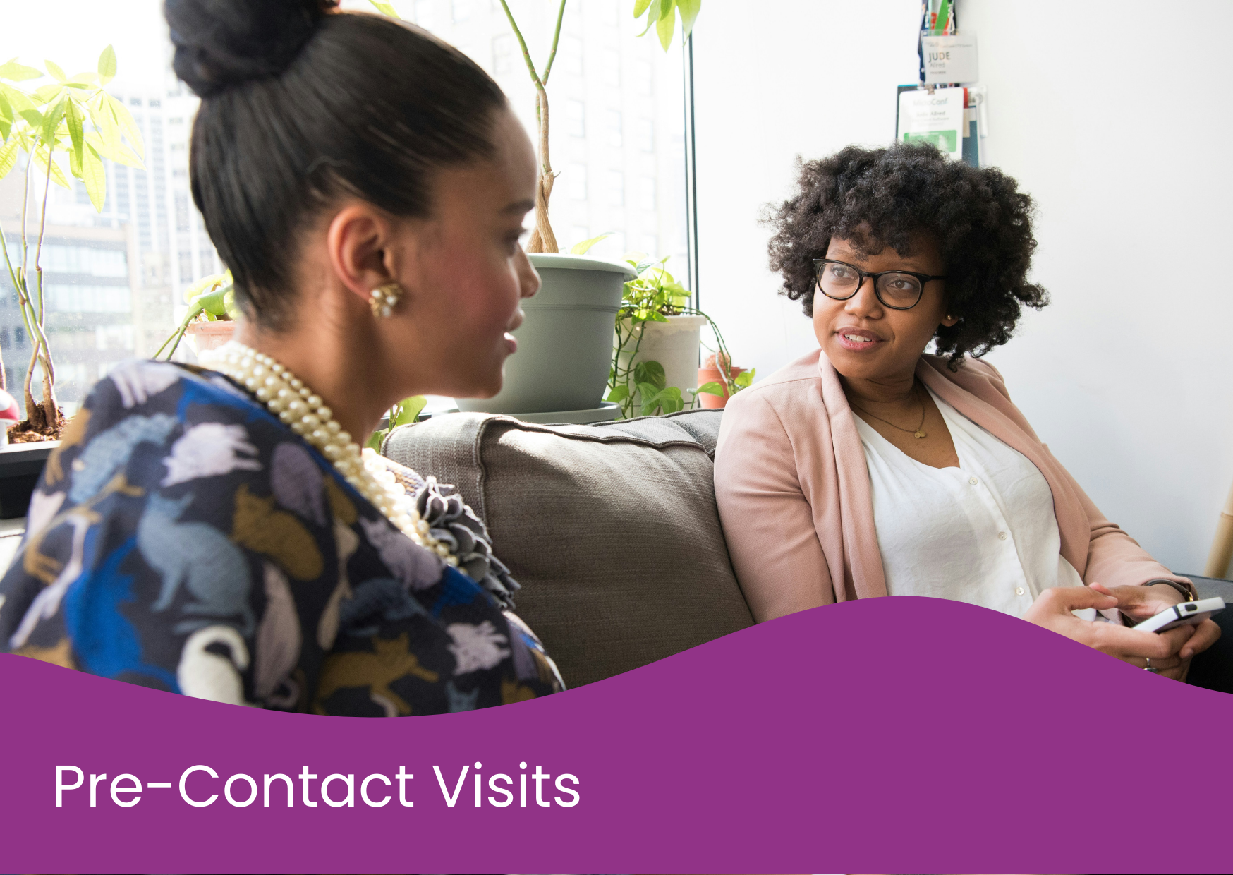 Two women having a conversation in an office or waiting area with potted plants and city buildings in the background, labeled as 'Pre-Contact Visits'.