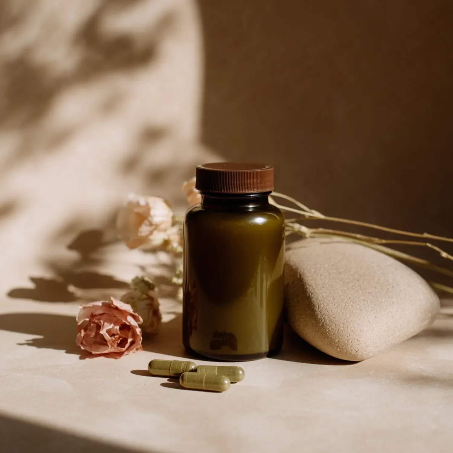 Brown bottle containing capsules and dried flowers—a symbolic image of dietary supplements and self-care