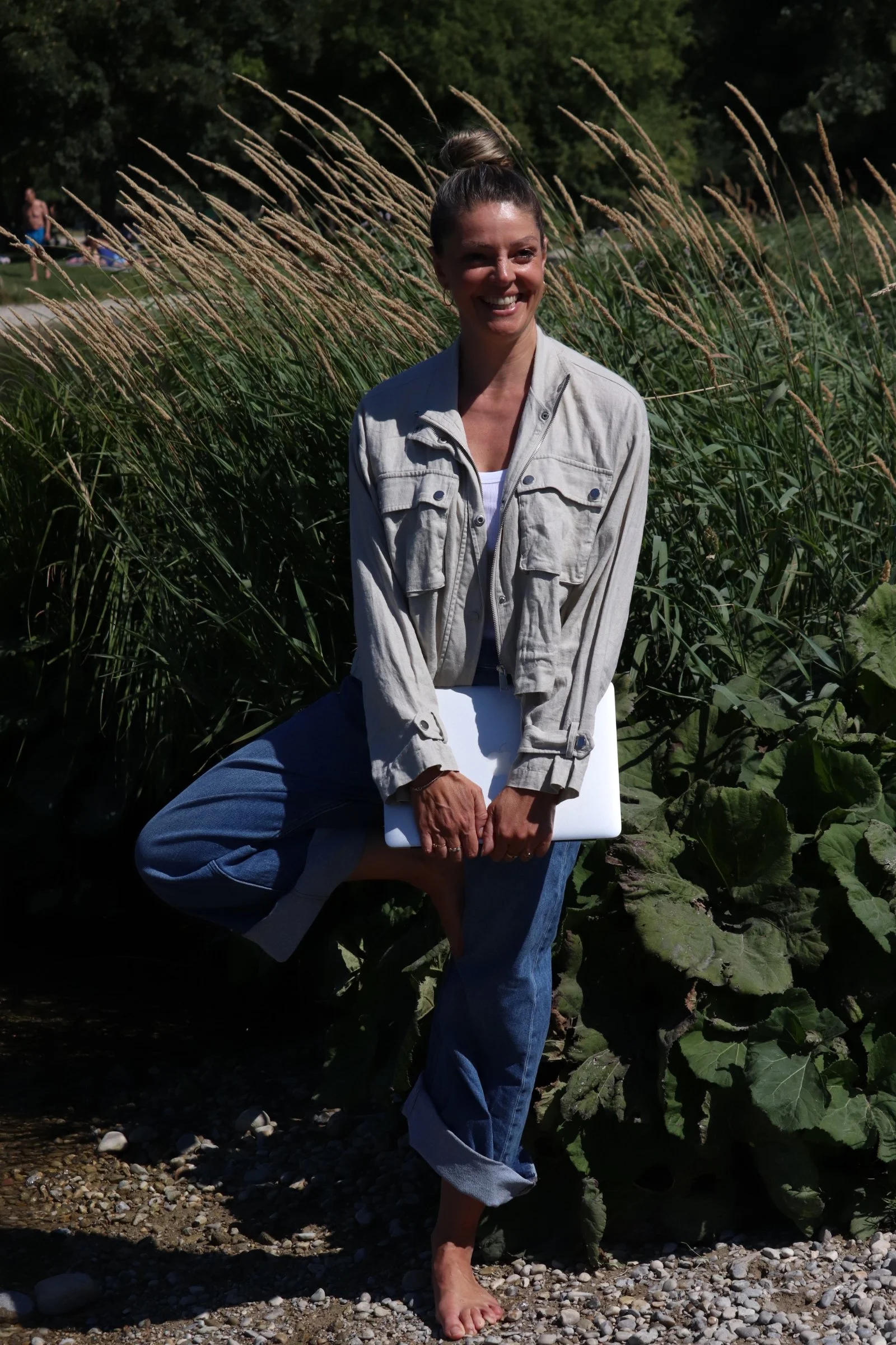 Petra Psenner smiling outdoors, barefoot on pebbles – Health Coach in Balance