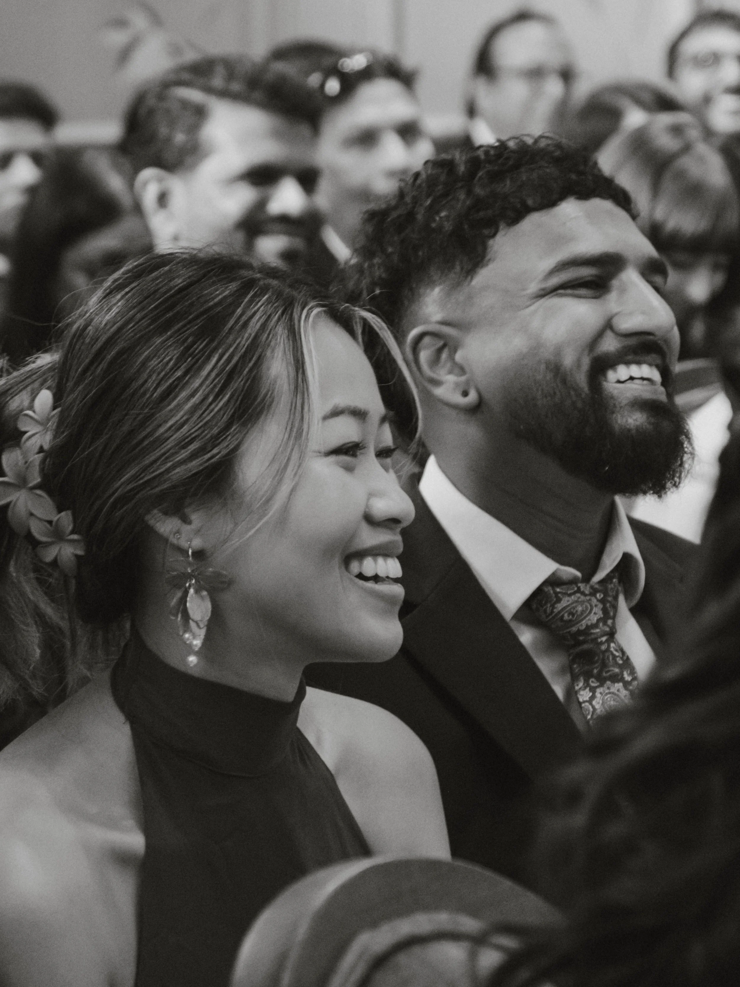 Group of people attending an event, smiling and dressed in formal attire.