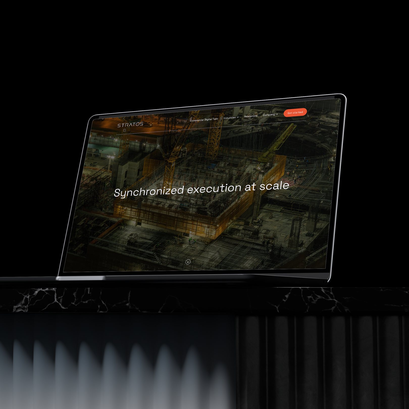 A computer screen displays a construction site at night with cranes and workers, with the phrase "Synchronized execution at scale" on the screen, set against a black background.