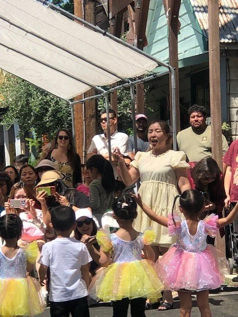 Chinese children wearing colorful tutus and princess costumes with their teacher dancing at the Locke Spring Festival 2026.