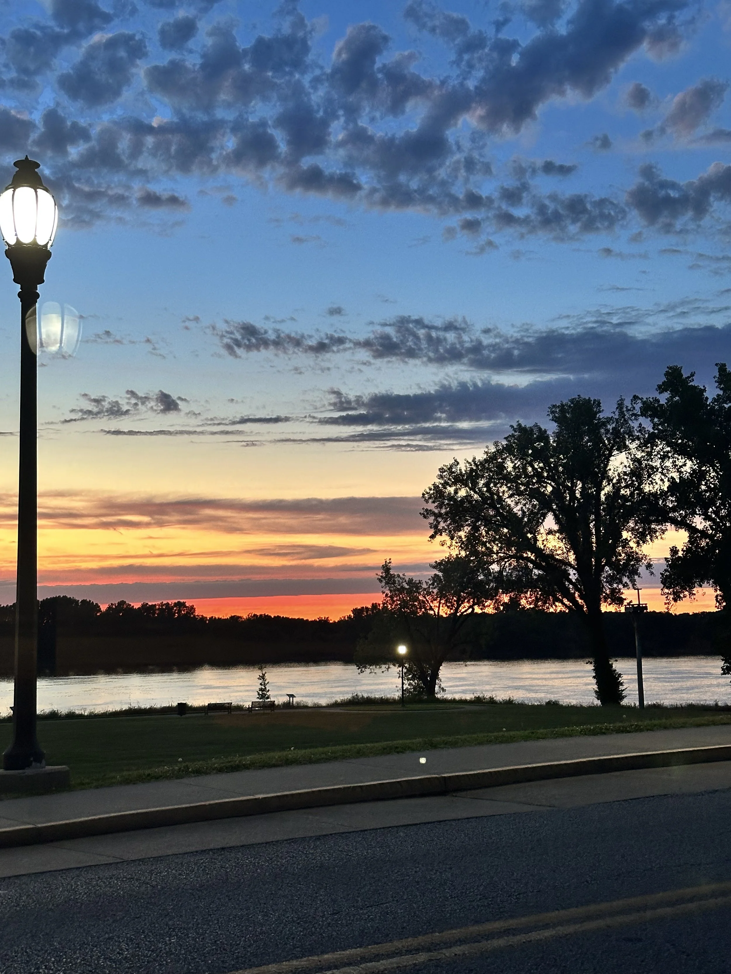 Sunset over the Ohio River in Henderson, Kentucky, featured on the official website of author, songwriter, and storyteller Rob Smith.