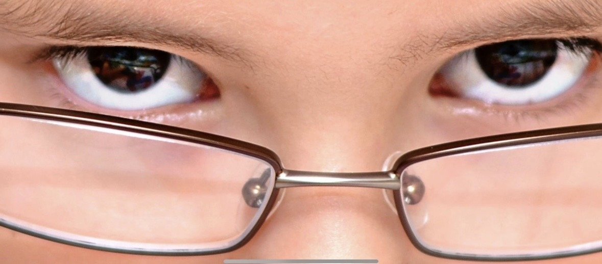Close-up portrait of a child’s eye reflecting Spider-Man artwork, photographed by Rob Smith.