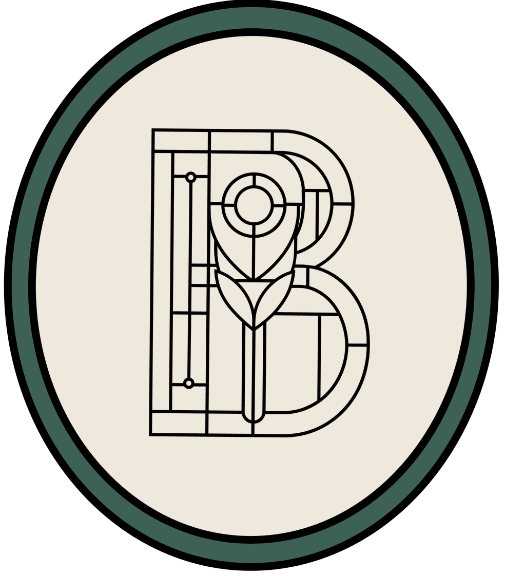 The Bradshaw oval brand logo graphic with dark green outline, cream colored interior and ornate B graphic in the center in the style of a stained glass window.