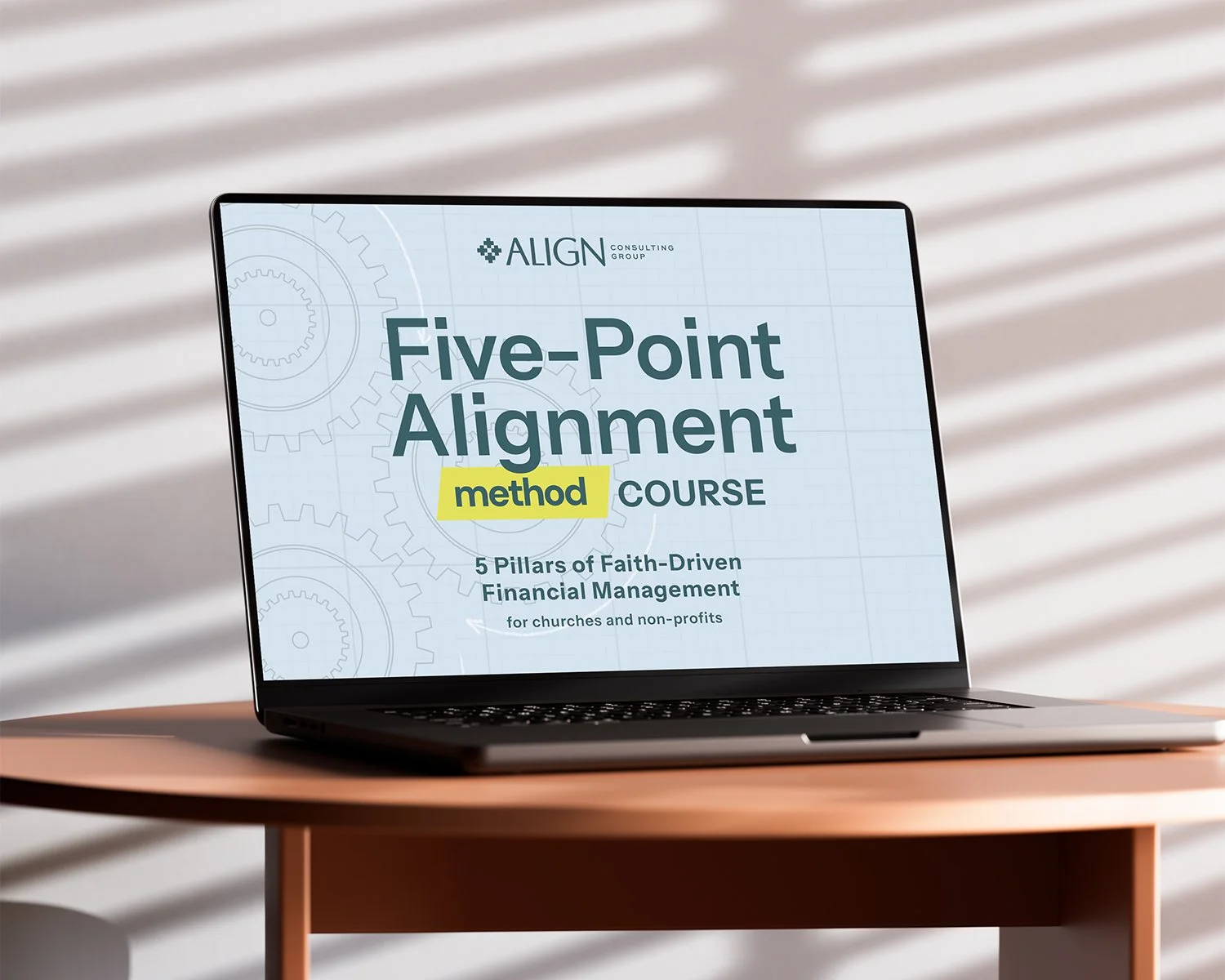 The Five-Point Alignment Method course shown on a laptop sitting on a wooden table