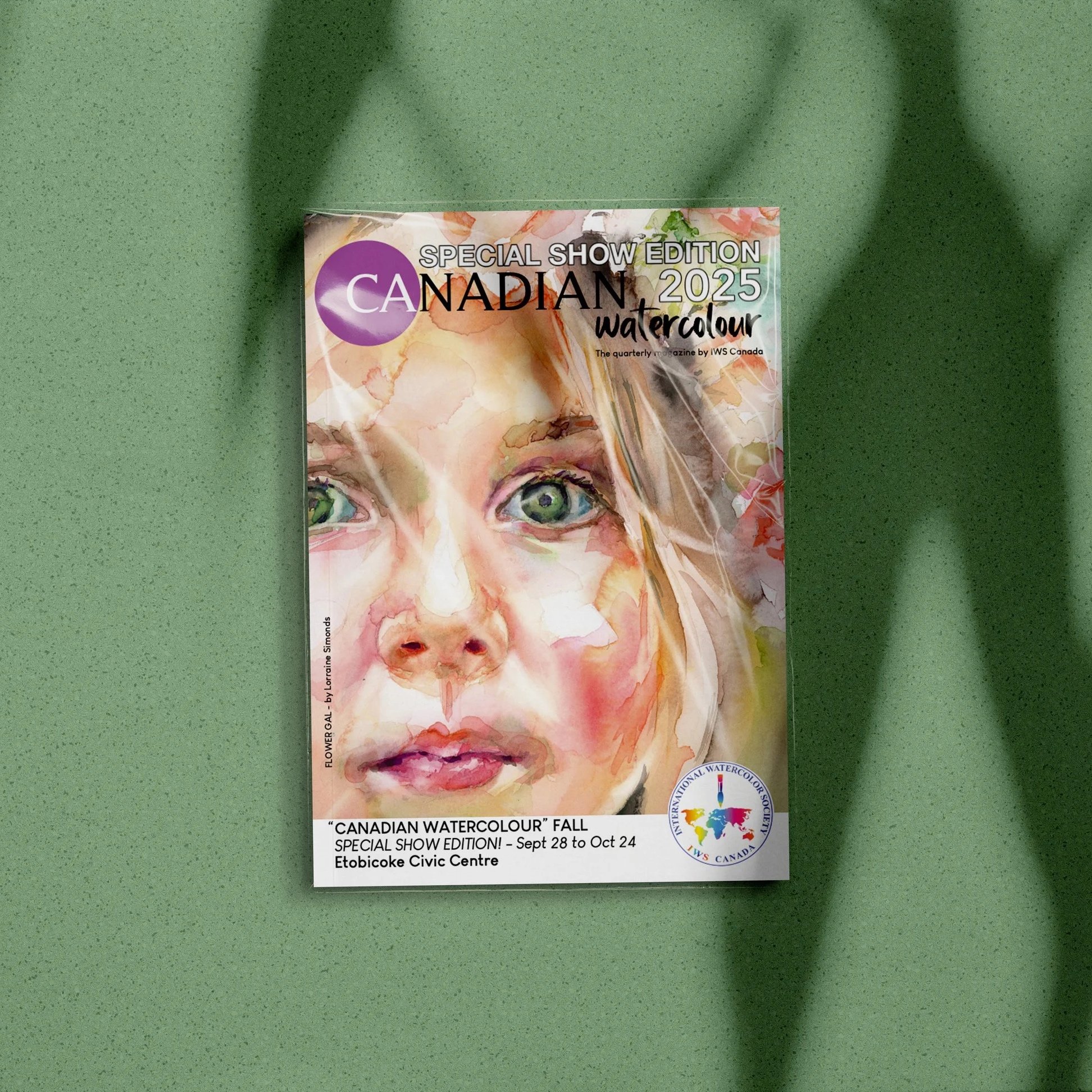 Poster for the Canadian Watercolour Fall Show 2025, featuring a watercolor painting of a woman's face with striking green eyes and flowing hair, placed on a green surface.