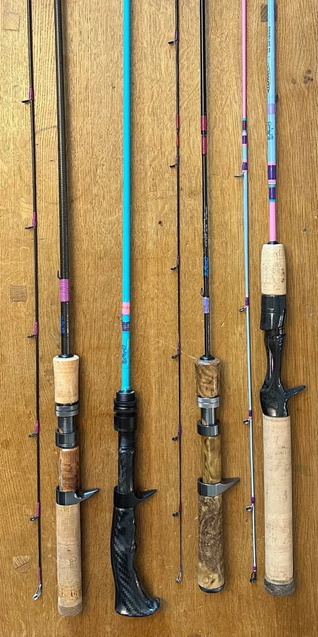 Four custom bait finesse system fishing rods showcasing a synthetic cork handle, carbon fiber pistol grip handle, burl wood handle, and cork handle