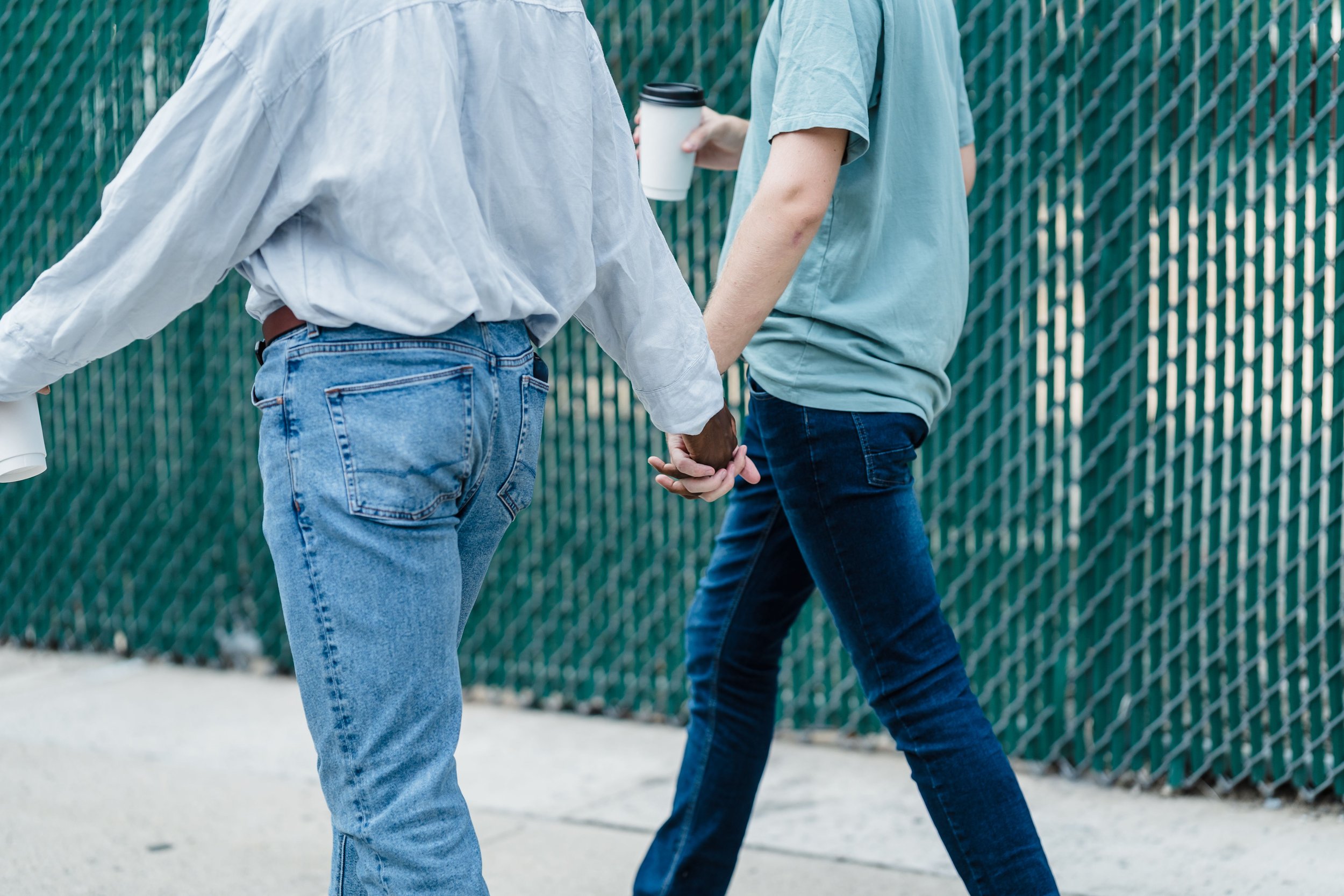 Two people holding hands, symbolizing connection, trust, and support in couples therapy.