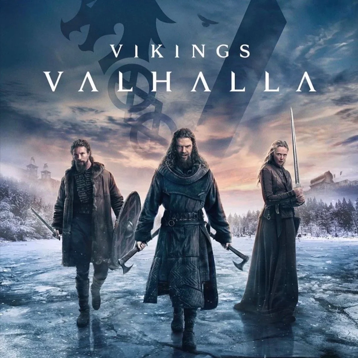 Three Viking warriors in armor and cloaks walking on an icy landscape with a snowy forest and buildings in the background, under a cloudy sky. The text 'Vikings Valhalla' appears at the top.