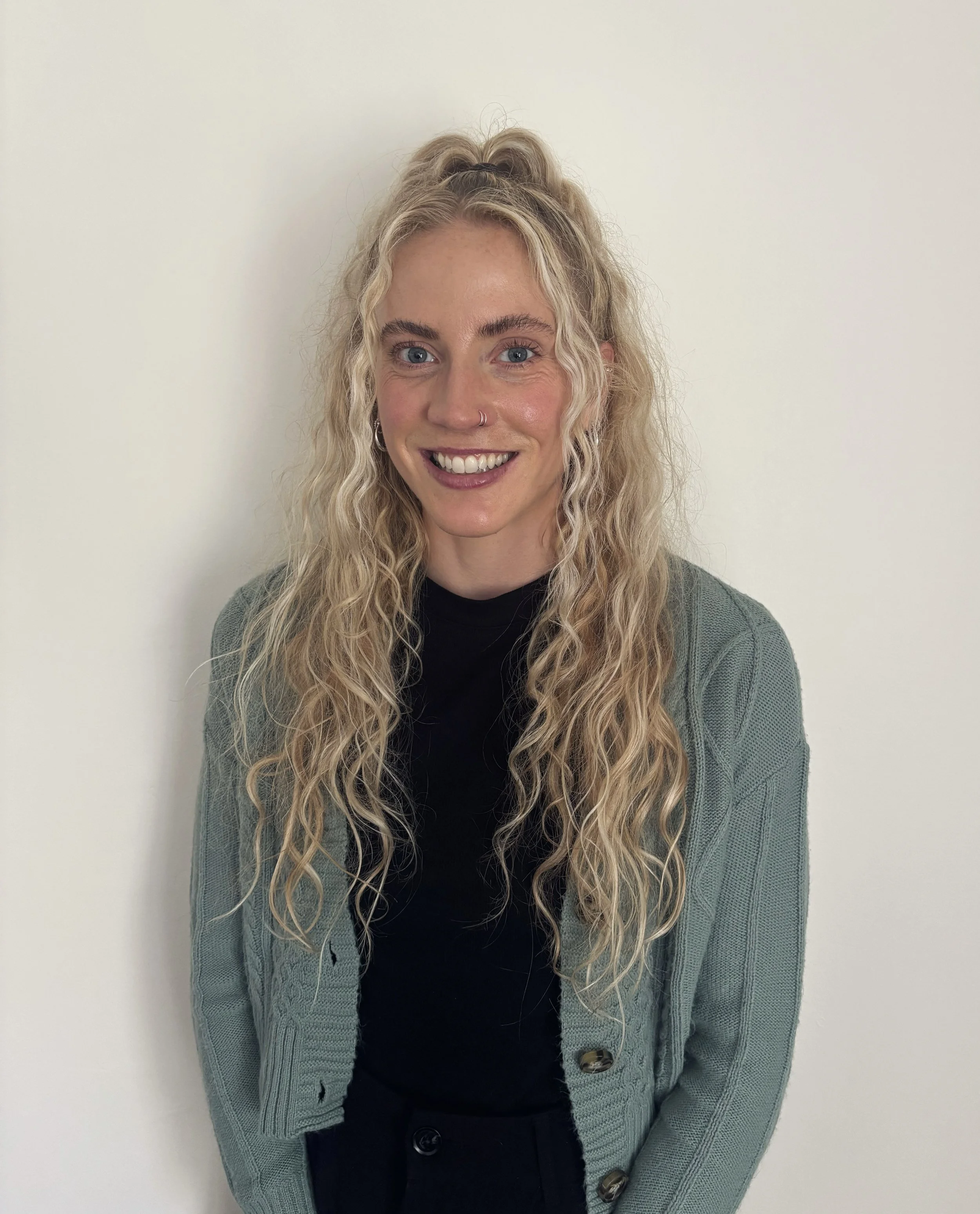 Dr. Paige Weyer smiling in a professional portrait against a white background