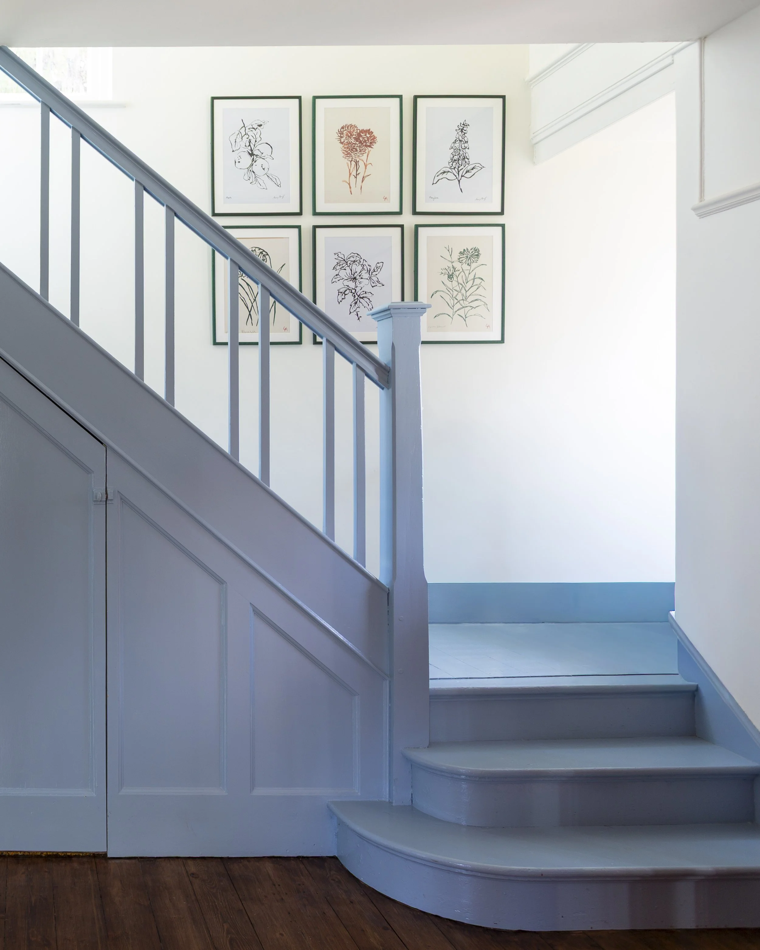 blue stairs In hallway with brown floor