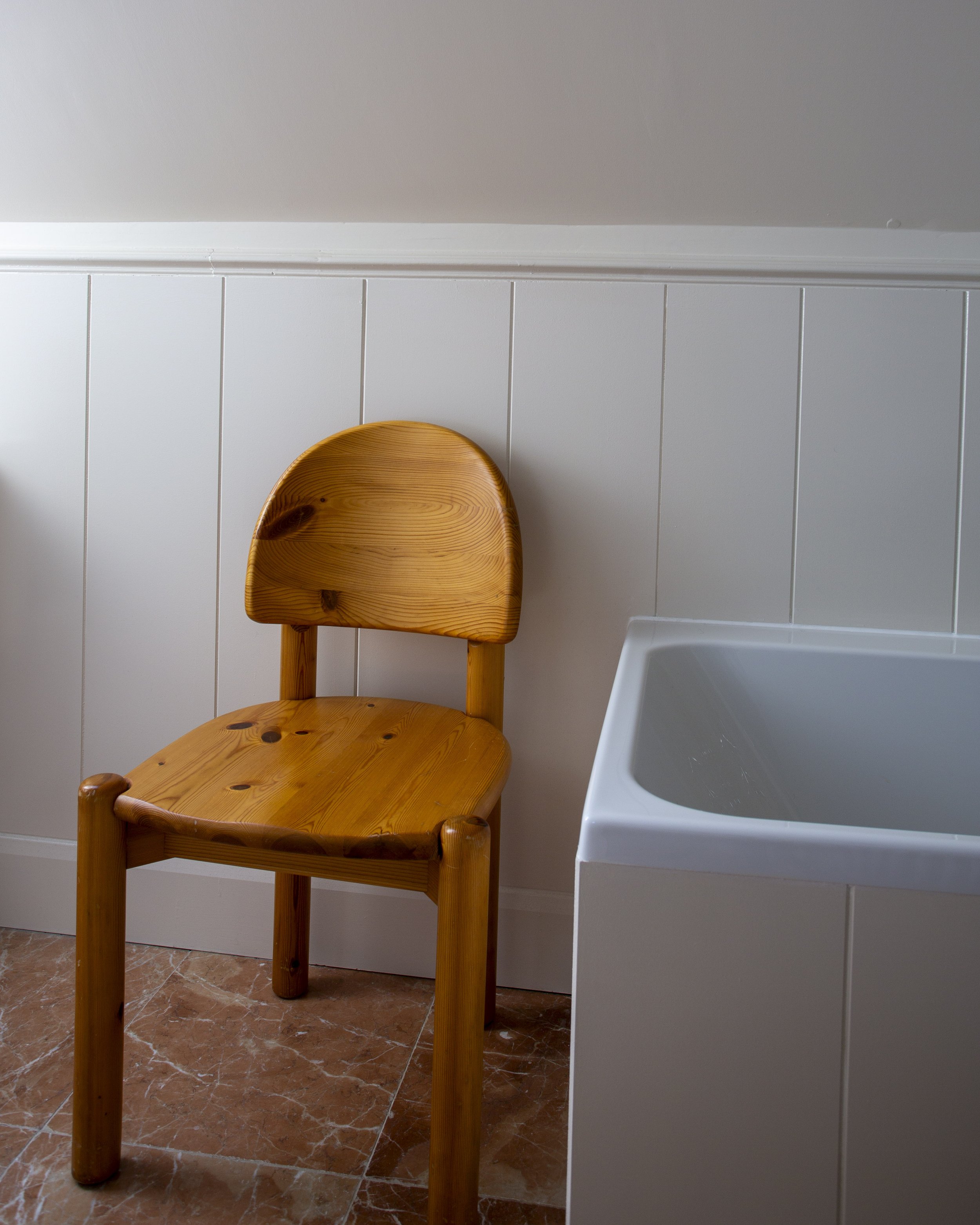 vintage Rainer deumiller chair next to bath