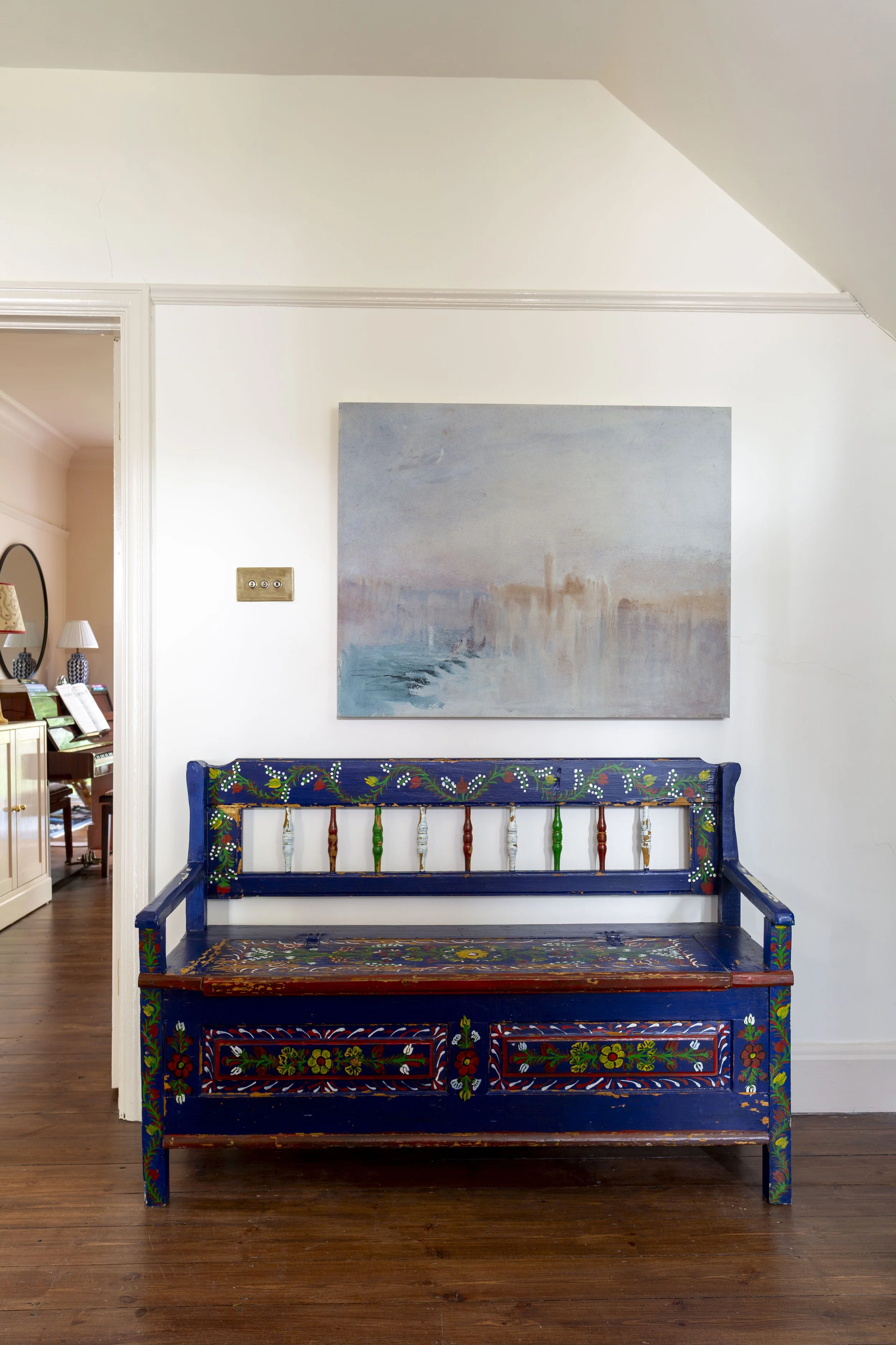 a vintage blue folk bench in a hallway