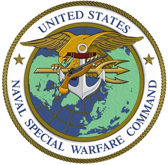 The emblem of the United States Naval Special Warfare Command, featuring an eagle, anchor, trident, and a world map, with the text 'United States Naval Special Warfare Command'.