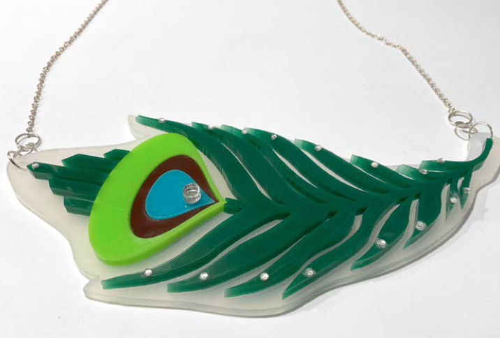 Fashion necklace designed to look like a peacock feather with colorful acrylic details.
