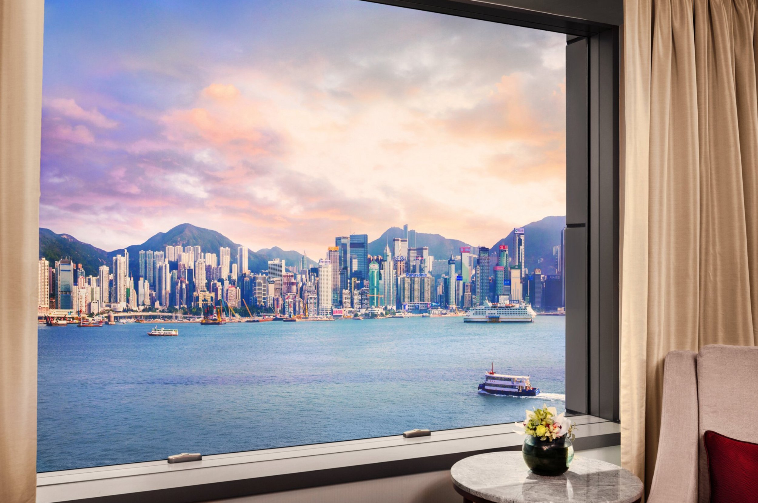 View from a luxury hotel room overlooking Victoria Harbour in Hong Kong, photographed by Vanessa Heisterkamp.