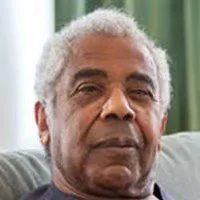 Portrait of an older man with gray hair and a neutral expression