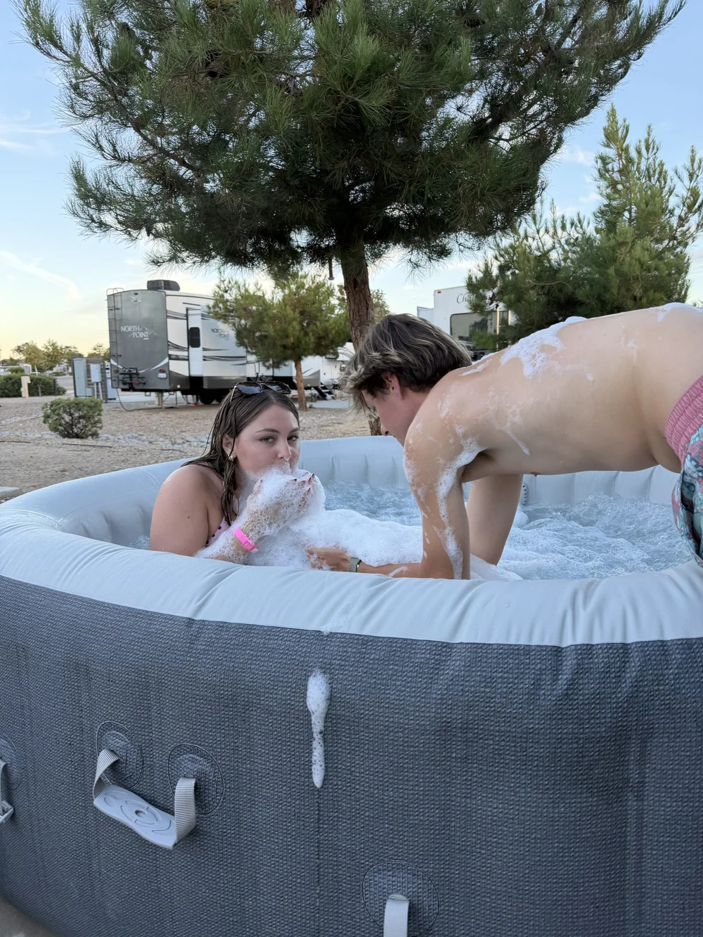 Private portable hot tub beside an RV campsite