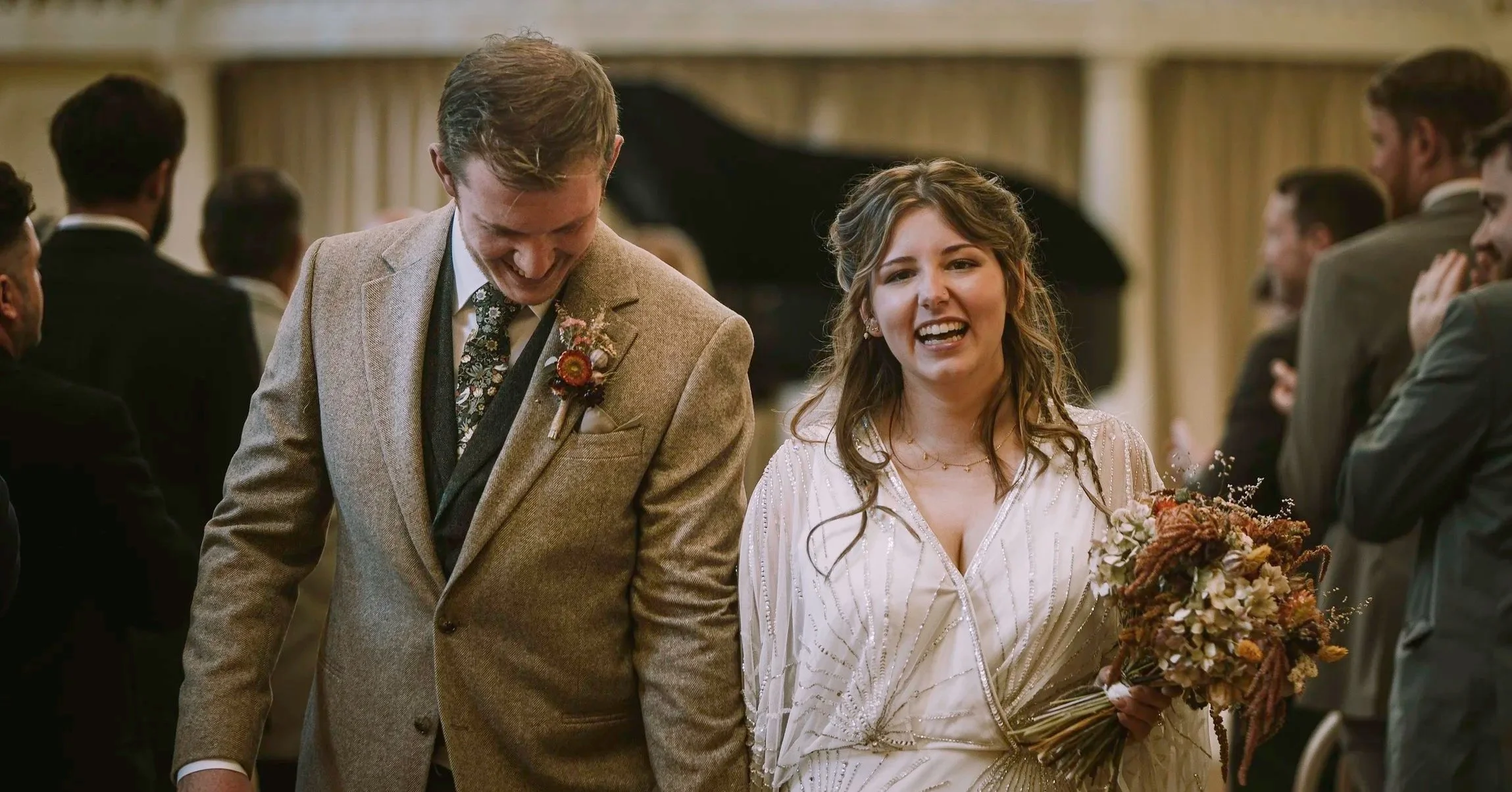 Groom and bride walking down the aisle post ceremony