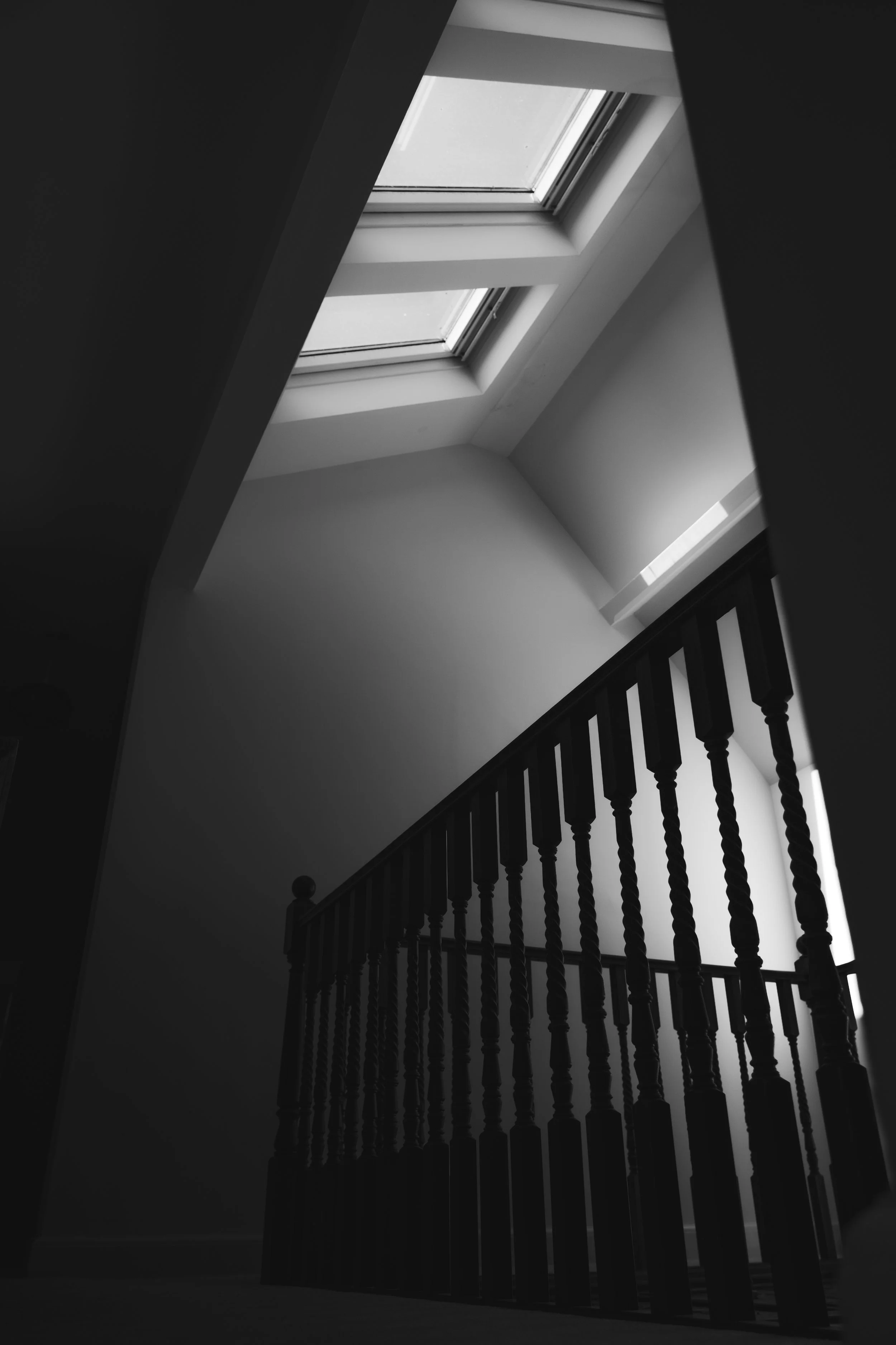 Black and white architectural photograph of a grand staircase inside a Norfolk wedding venue.