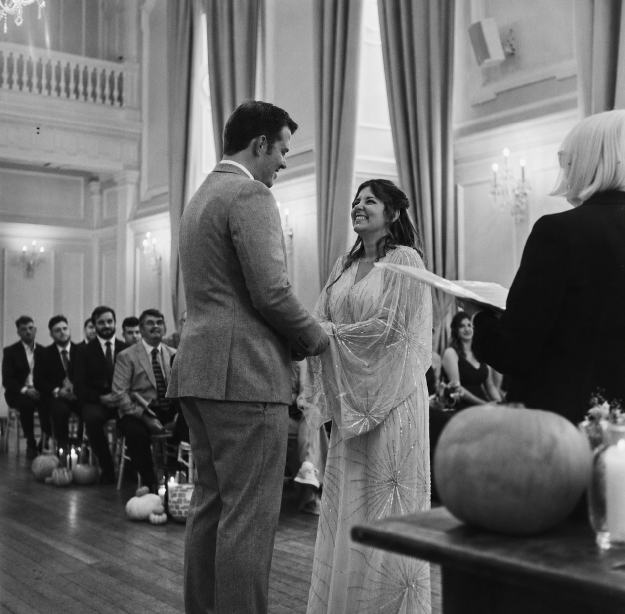 Bride and groom exchanging vows during a documentary-style wedding ceremony in Norfolk, photographed naturally without posing.