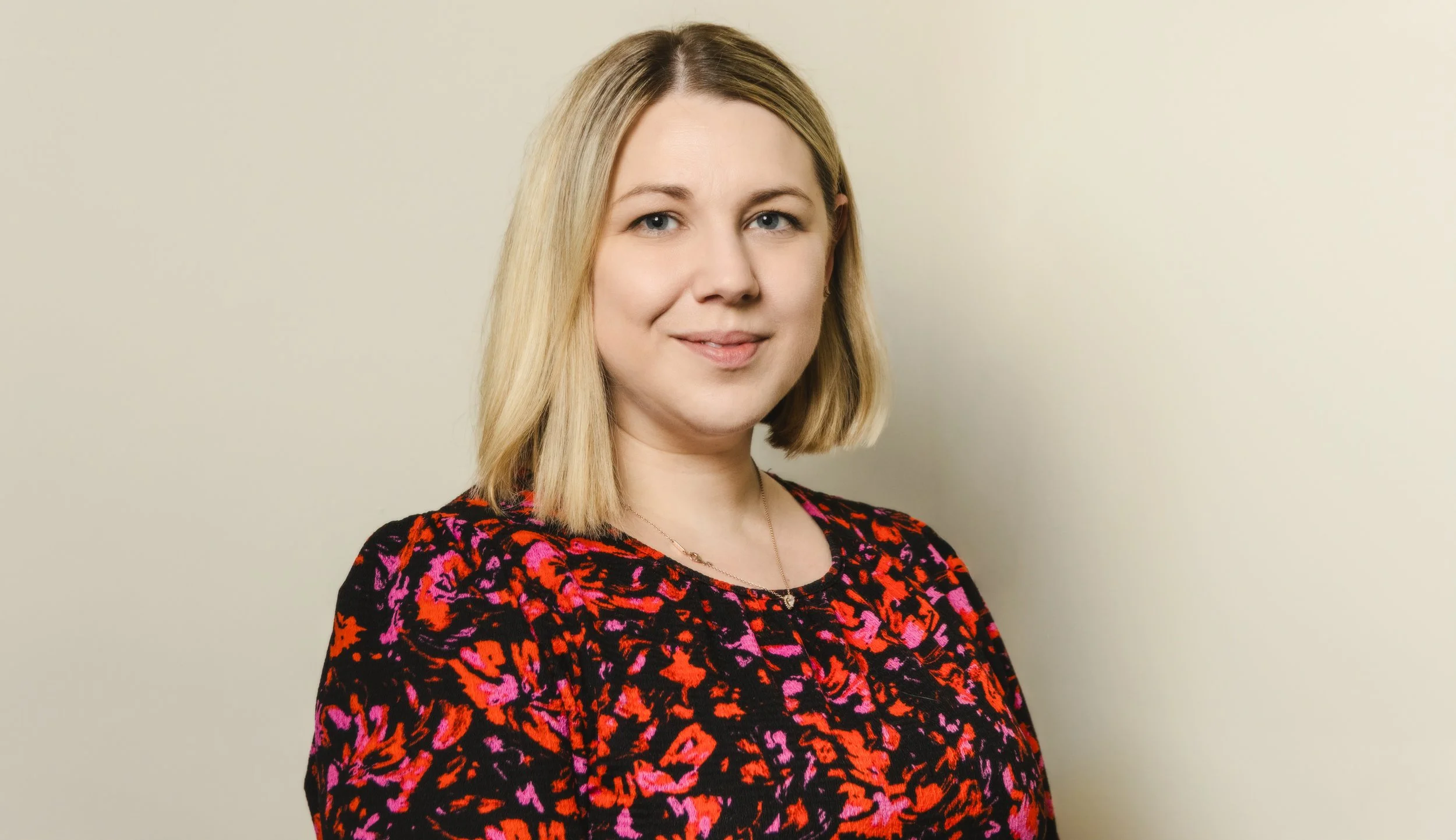 A woman posing for a Professional corporate headshot for a Norfolk business.