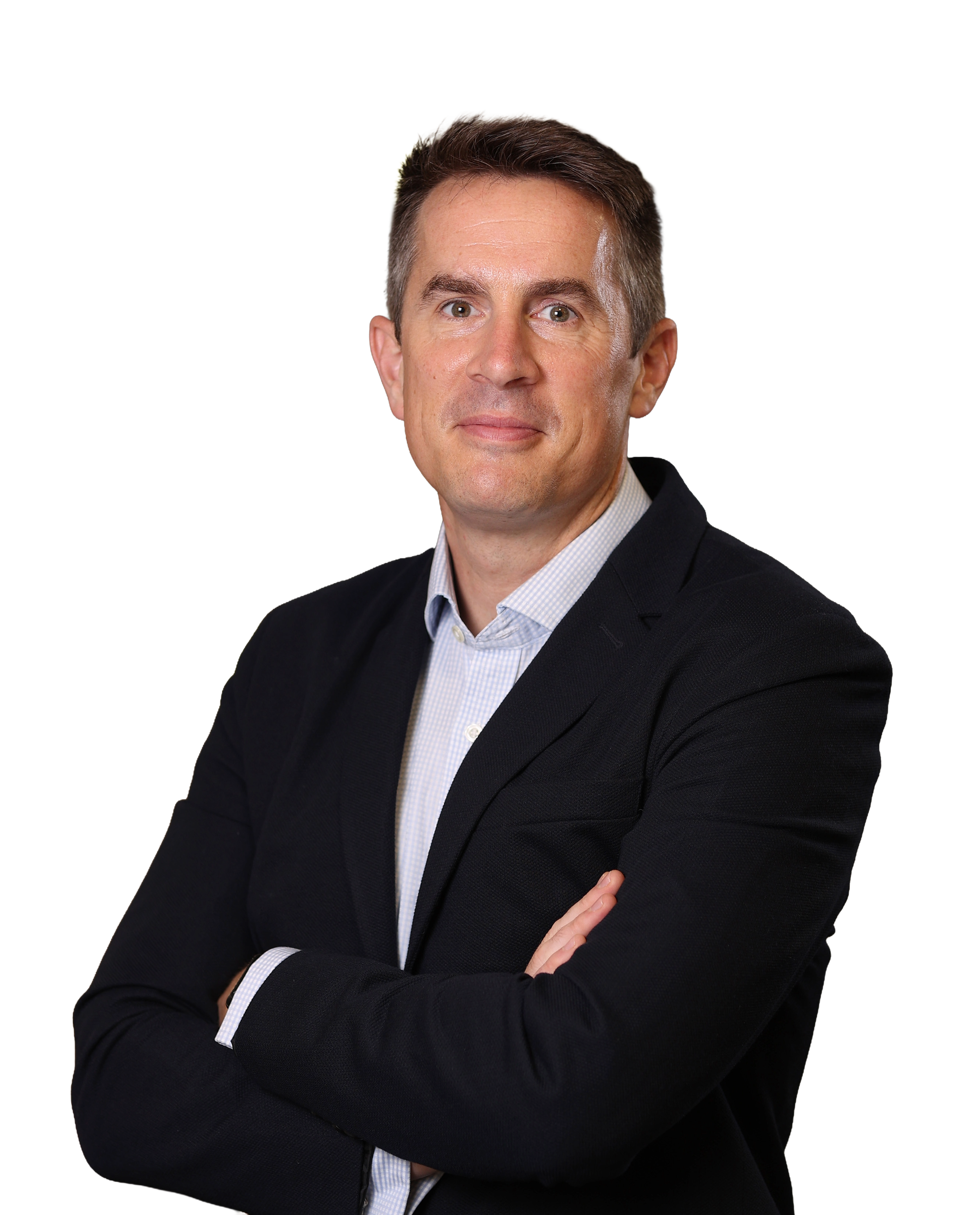 A man in a dark suit with a light blue shirt, crossing his arms and looking directly at the camera.