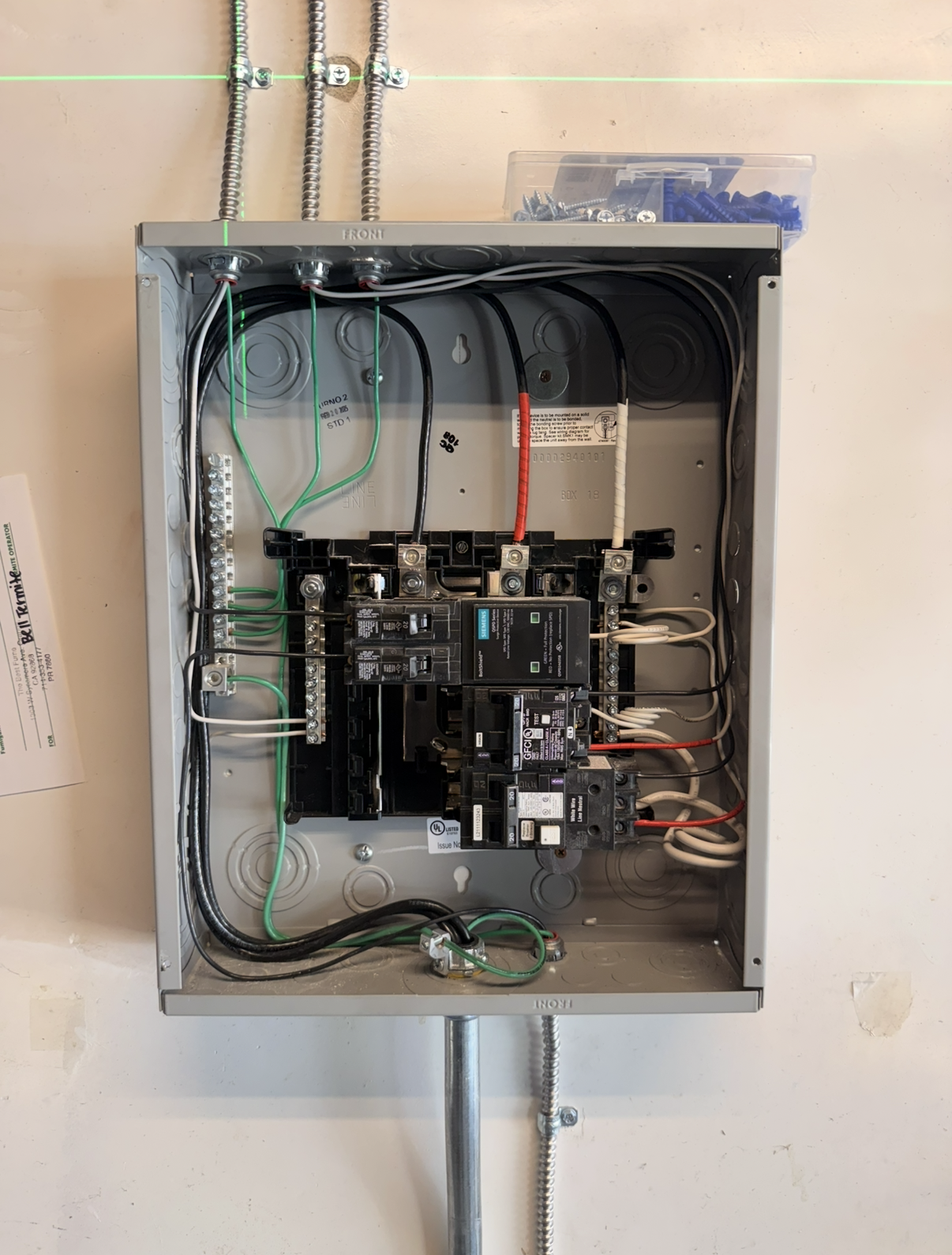 Open electrical panel showing wiring and circuit breakers.