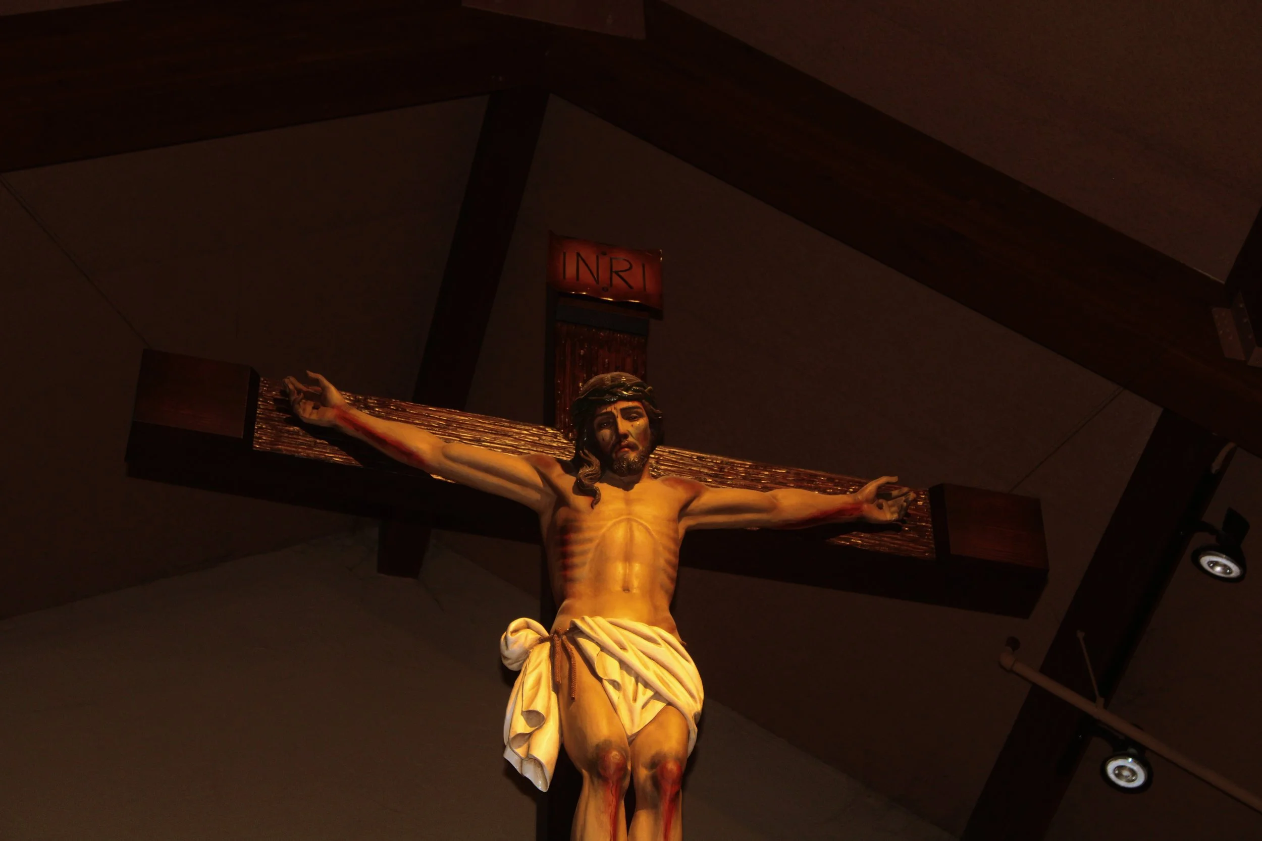 Crucifixion statue of Jesus Christ on a cross, with a sign above reading 'INRI'.