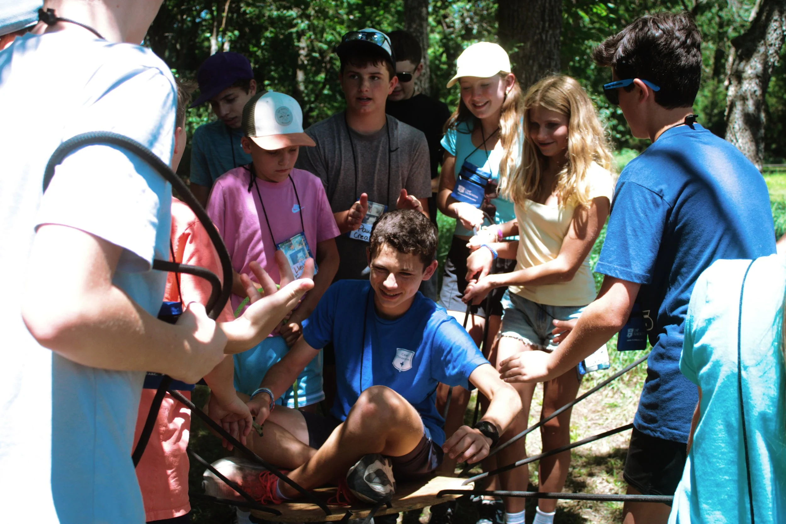 Group of children outdoors participating in team-building activity, holding hands and working together