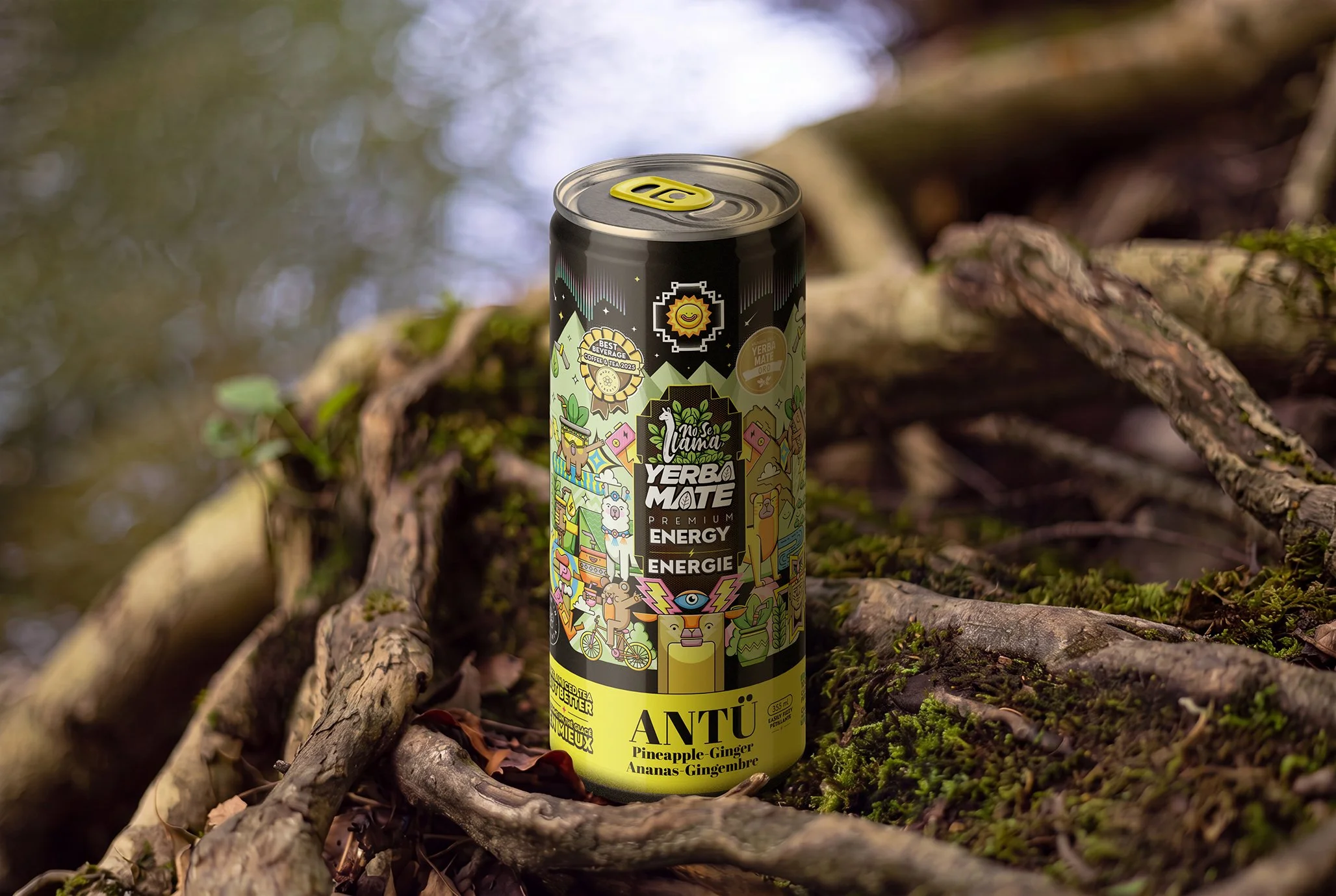 A can of Yerba Mate energy drink with colorful, cartoon-style illustrations is placed on mossy logs outdoors, surrounded by tree bark and greenery.