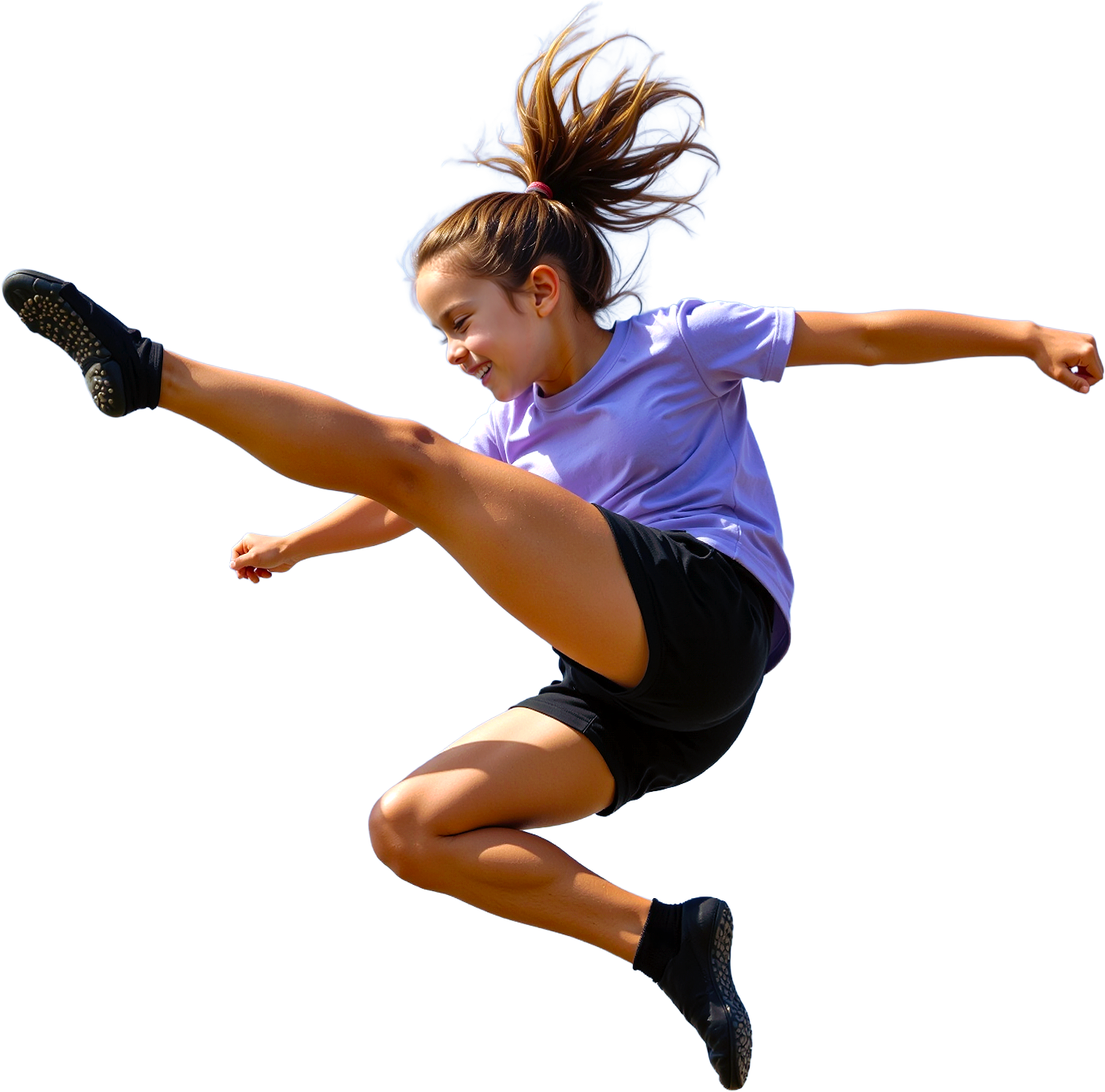 Young girl with a ponytail jumps in the air with an extended leg, smiling against a blue sky.