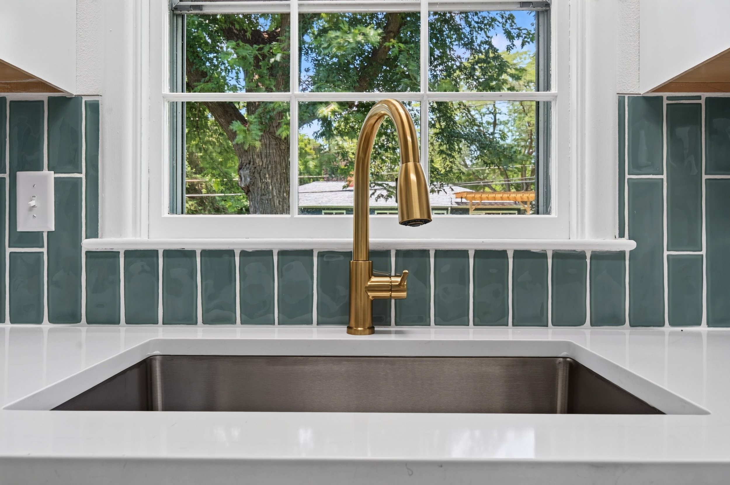 Kitchen sink professionally photographed for a real estate listing in Des Moines, Iowa.