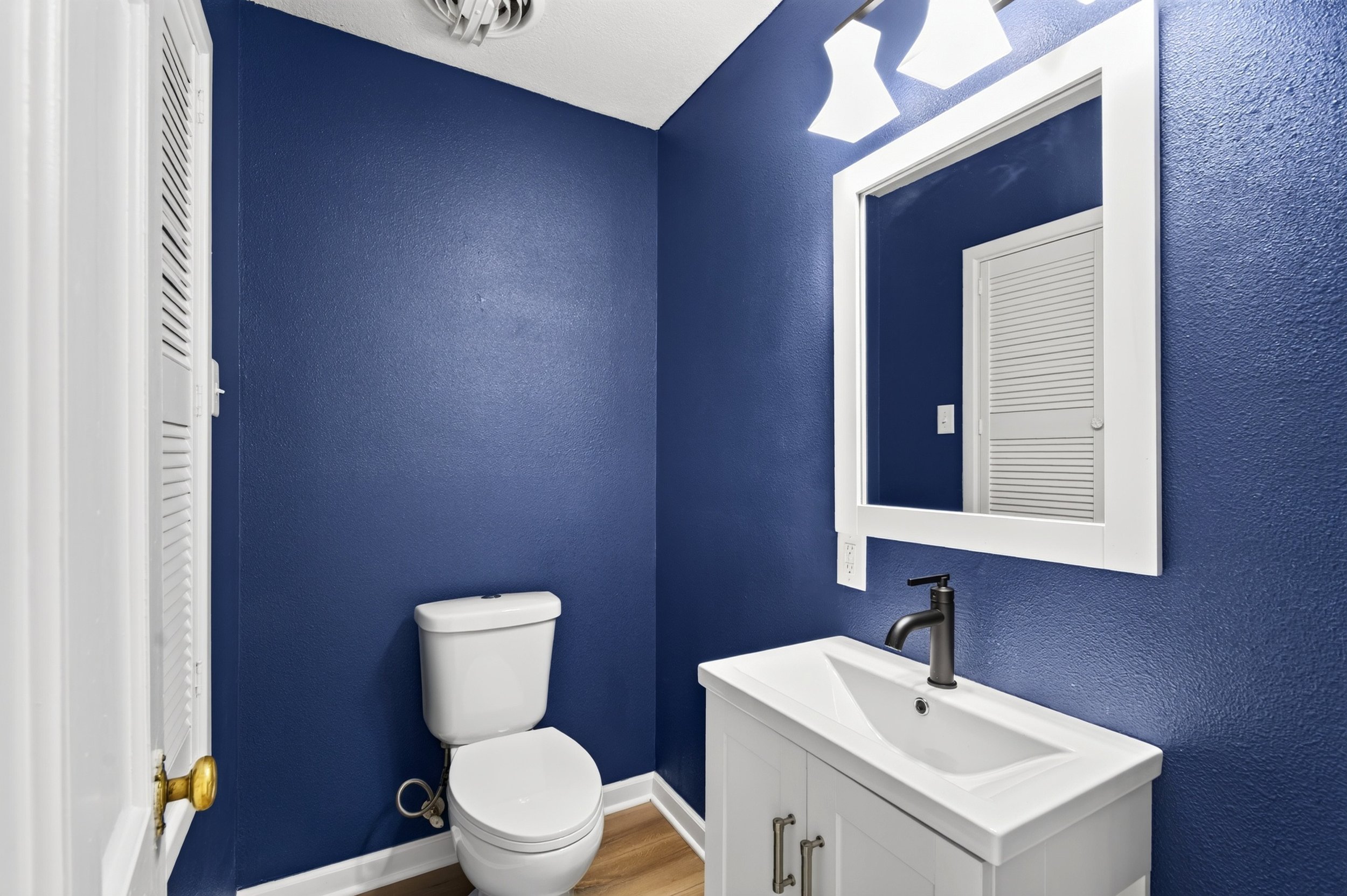 Half bath professionally photographed for a real estate listing in Des Moines, Iowa.