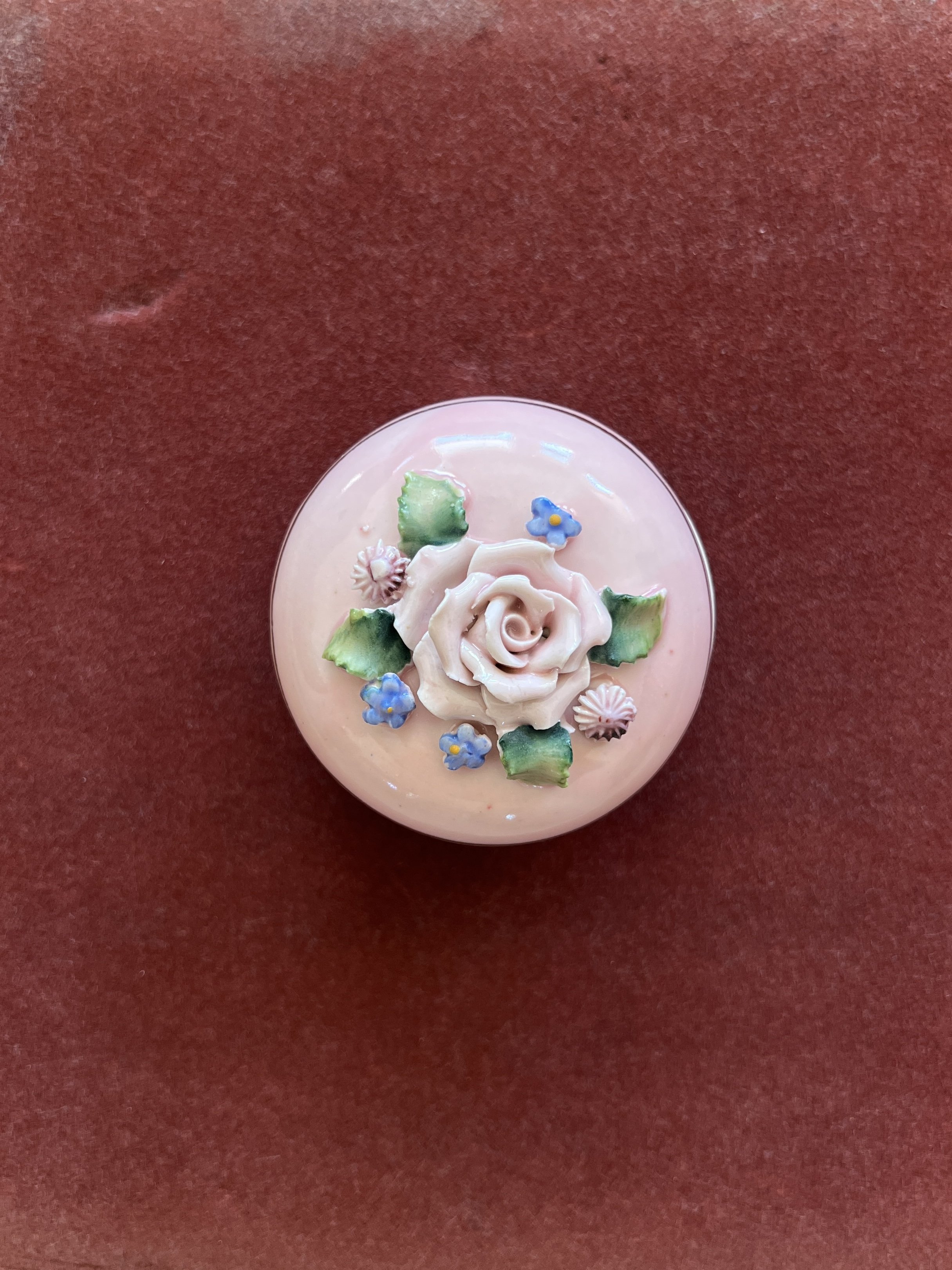Pink porcelain trinket box with floral details