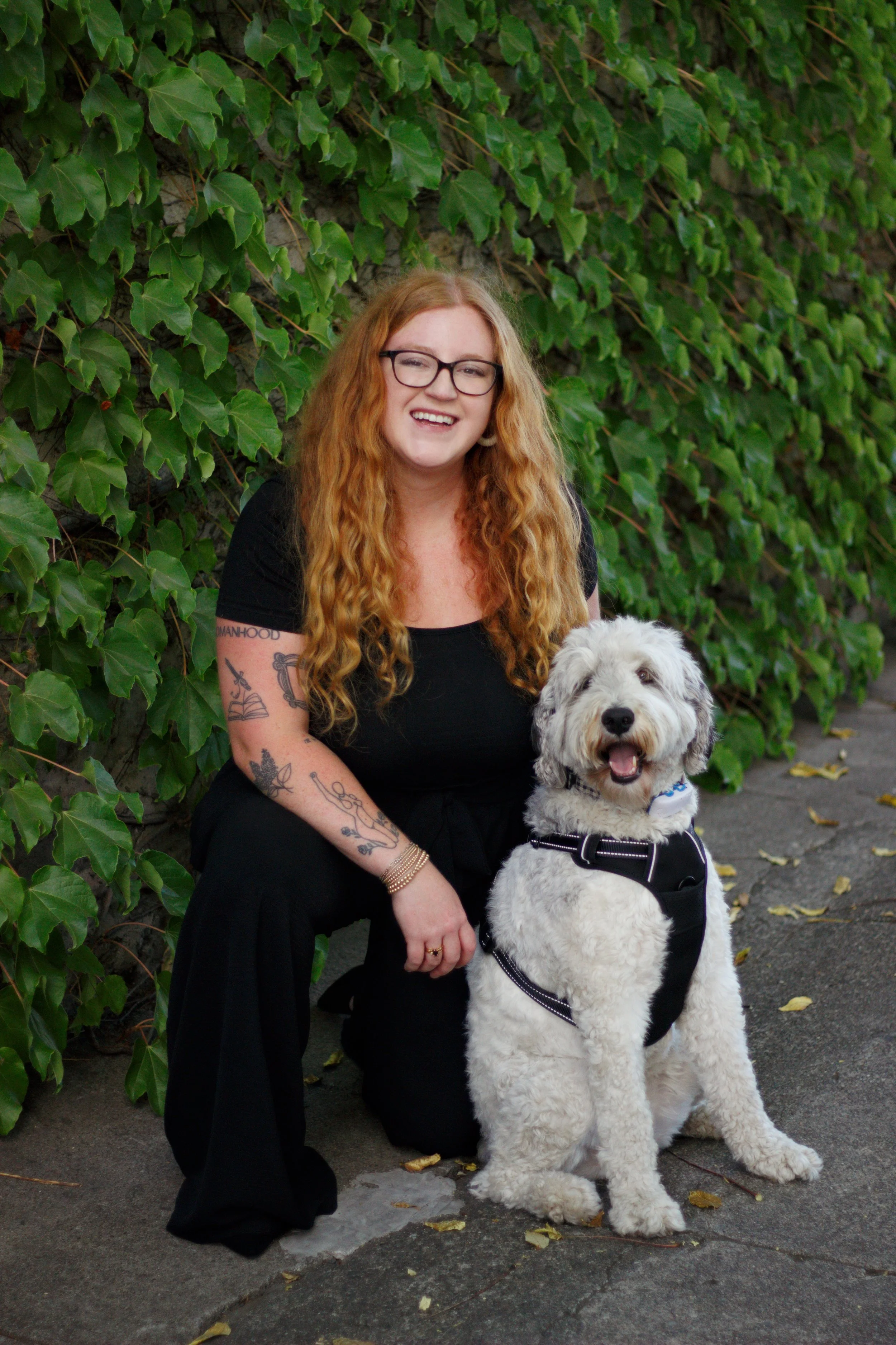 Chloe Melka, LPCC, outdoors in Pacific Grove with her dog and tablet, providing virtual therapy for women in Monterey County and California.